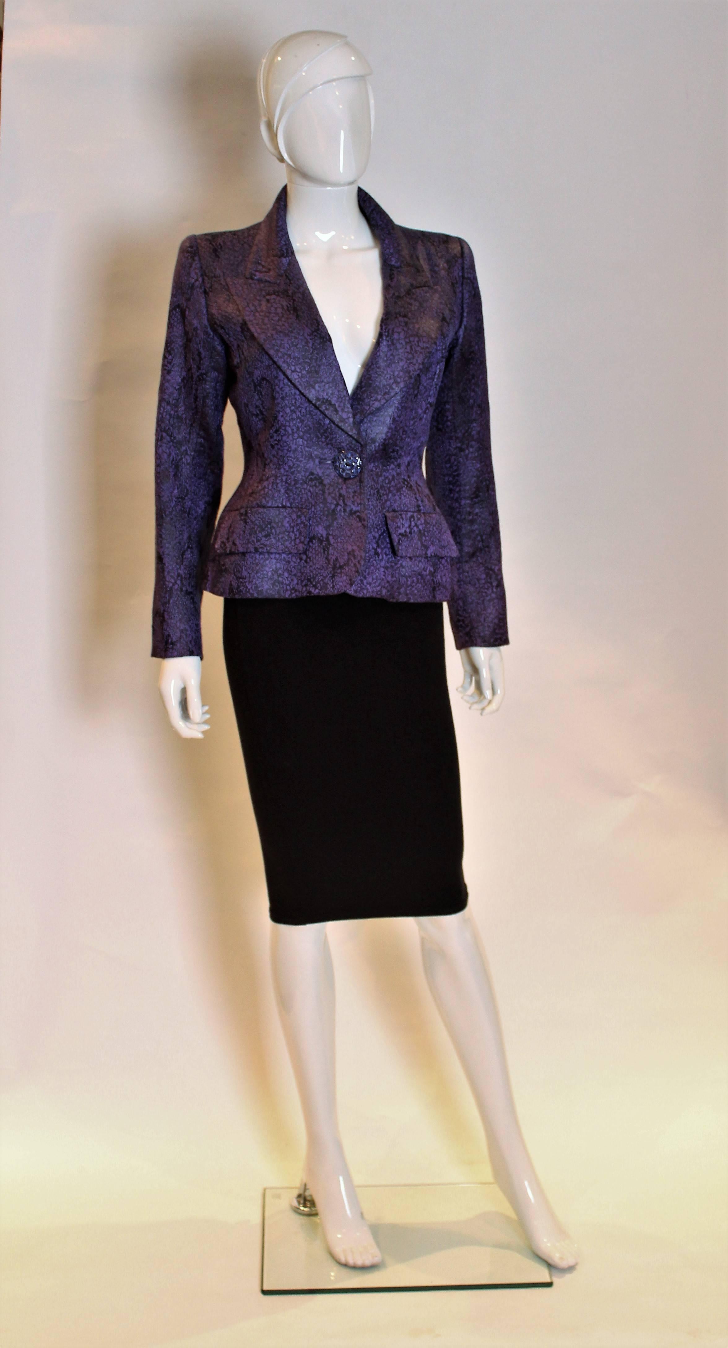 A stunning jacket by Yves Saint Laurent , Rive Gauche line. This jacket has wonderful tailoring and the fabric  is lilac and black in colour with a slightly metallic sheen.It has a one button fastening.
