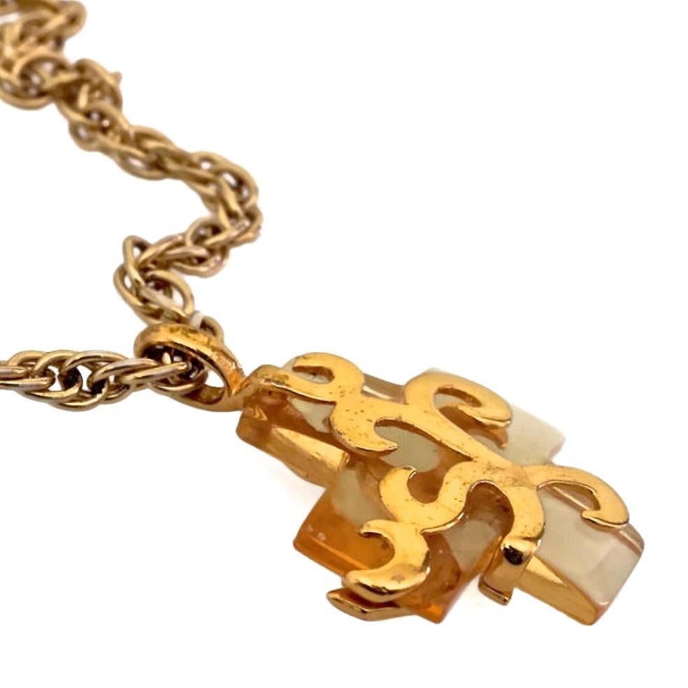 Vintage YVES SAINT LAURENT Lucite Gold Overlay Cross Necklace

Measurements:
Height: 1 5/8 inches
Width: 1 5/8 inches

Features:
- 100% Authentic YVES SAINT LAURENT.
- Cross lucite pendant with opulent pattern gold metal overlay.
- Gold tone
