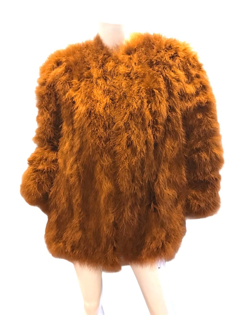 1980s Yves Saint Laurent oversized orange feathered jacket. Two pockets. Hook eye closure.
Condition: Excellent
Size M  - L 
40