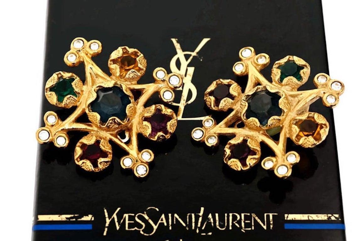 Vintage YVES SAINT LAURENT Multi Colored Stone Earrings

Measurements:
Height: 1 7/8 inches
Width: 1 7/8 inches

Features:
- 100% Authentic YVES SAINT LAURENT.
- Inverted square with multi colored stones and clear rhinestones at the corners.
-