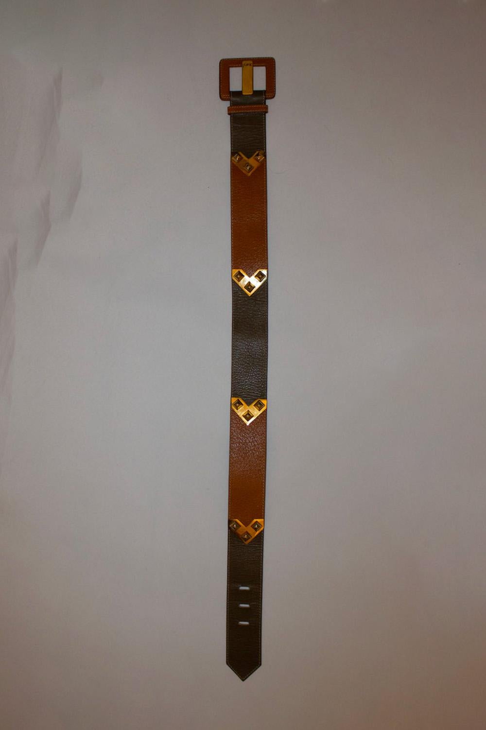 A great vintage leather belt by Yves Saint Laurent.
In olive and brown leather it has decorative gold detail and a square buckle.
Made in France Model 598 75/30
Length 35'', height 2''