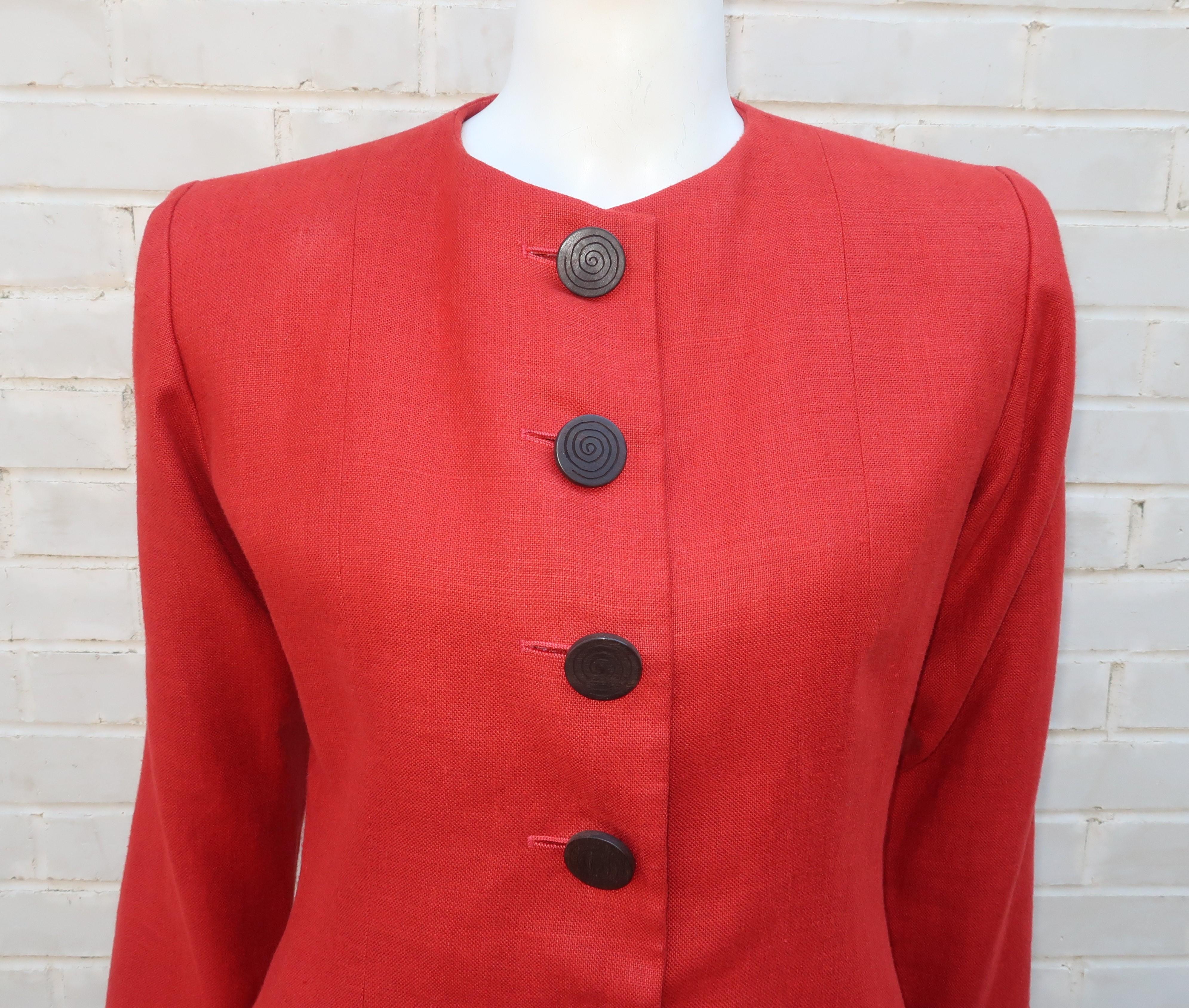 A vintage Yves Saint Laurent Rive Gauche rust orange linen collarless jacket with cutaway hemline.  The jacket closes at the front with large exotic wood buttons.  Pair it with animal or tropical prints for warm weather looks or create a safari