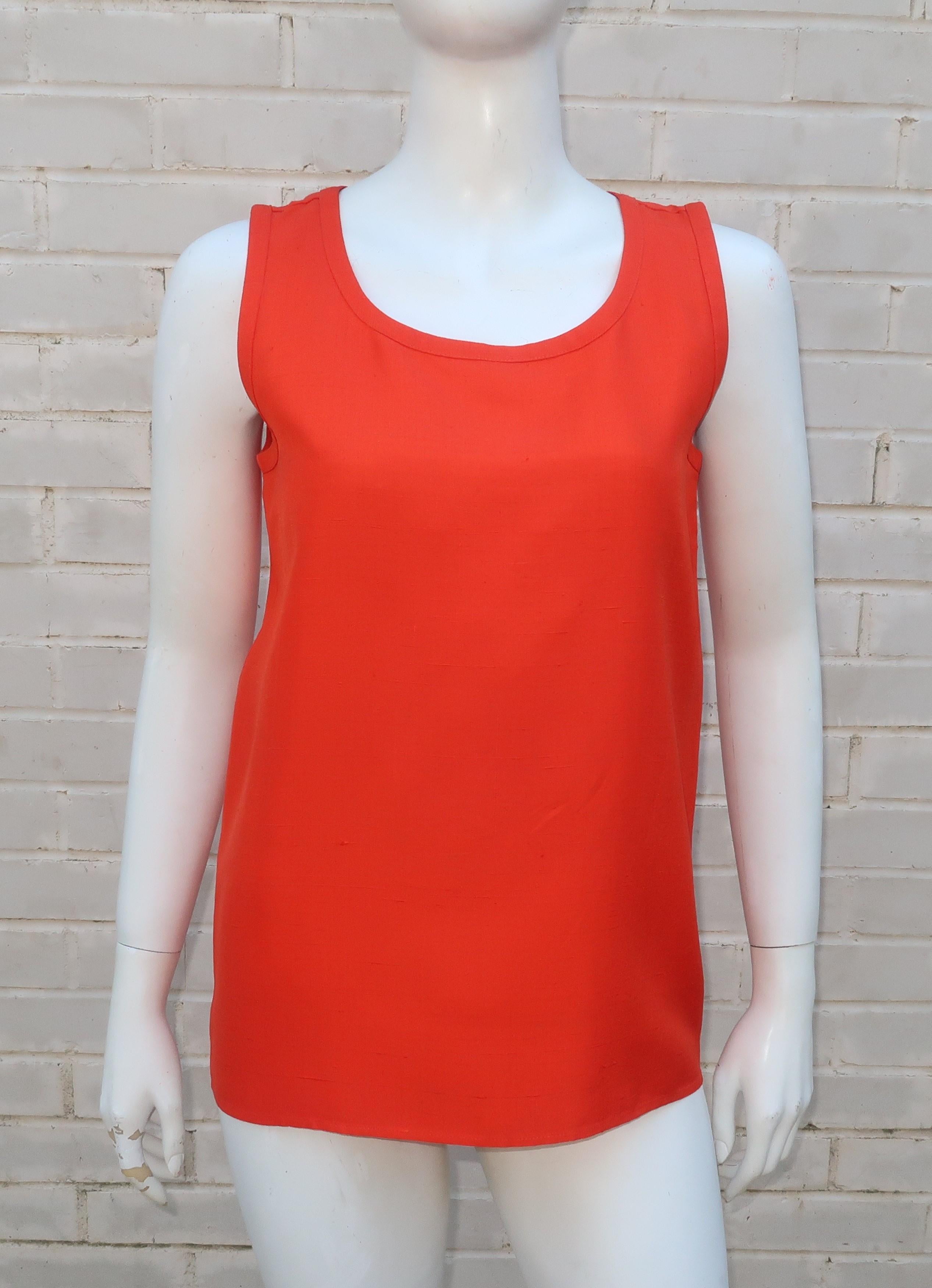The vibrant orange shade of this simple Yves Saint Laurent Rive Gauche sleeveless blouse will add a color pop to anything and everything.  Fabricated from a beautiful nubby raw silk that offers both texture and a crisp appearance for a stand alone