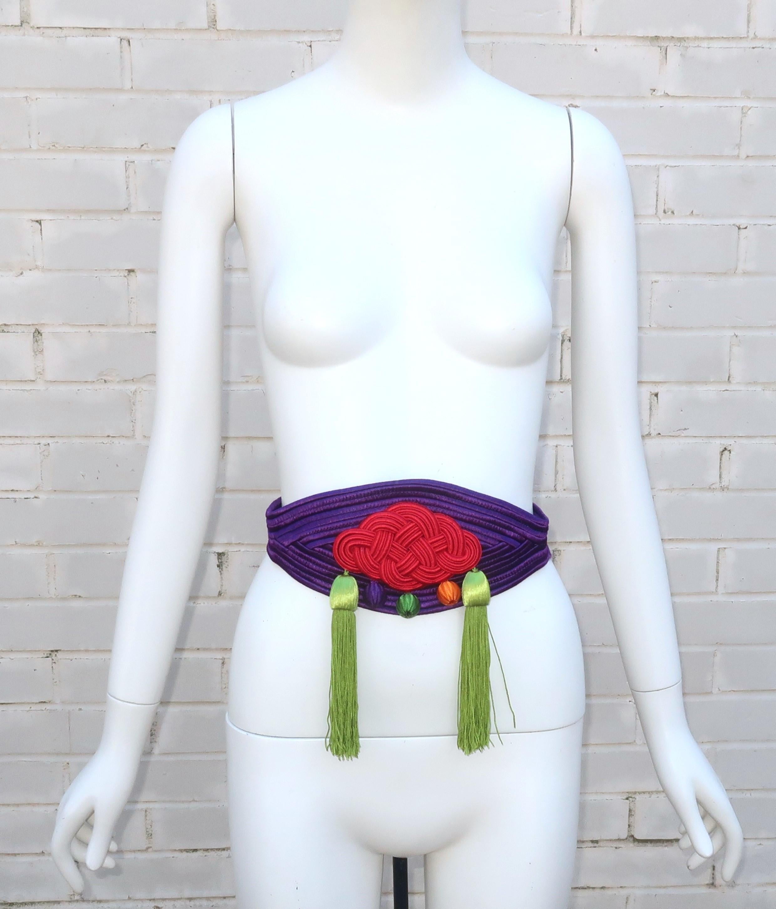 Vintage Yves Saint Laurent cummerbund style belt designed in silk passementerie with tassels.  The opulent look is pure YSL with an eye catching combination of colors including royal purple, red, green, orange and lime green.  The belt hooks and