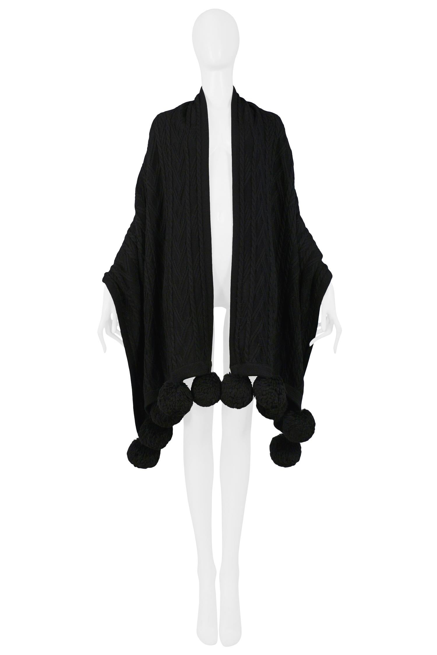 Vintage Yves Saint Laurent black wool cable knit shawl edged with large pom poms.

Excellent Condition.
