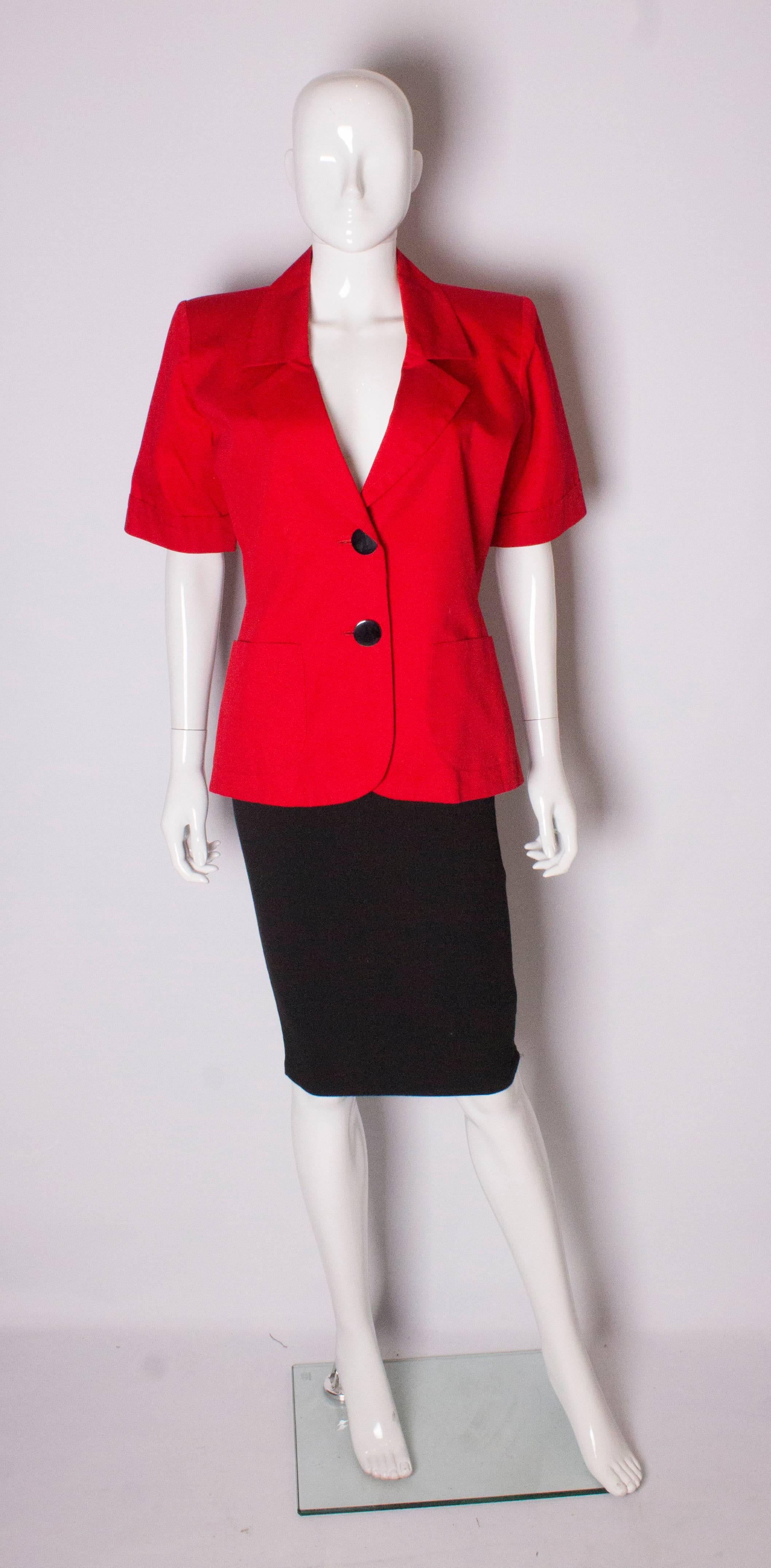 A great short sleeved jacket by Yves Saint Laurent , Variation line. The jacket has 2 large buttons at the front and 2 pockets at waist level.