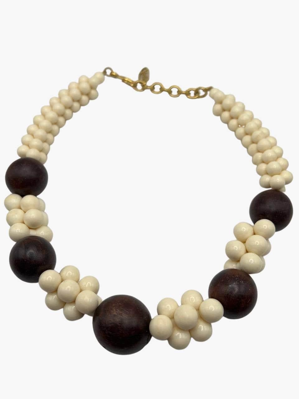 Vintage massive ivory resin and dark-brown wood beaded necklace by Yves Saint Laurent. Gold-tone metal hook closure. 
Signed. YSL mark on the clasp. 
Year: 1967 (SS67 African Collection)
Length: 48cm
Condition: Very good. no visible signs of