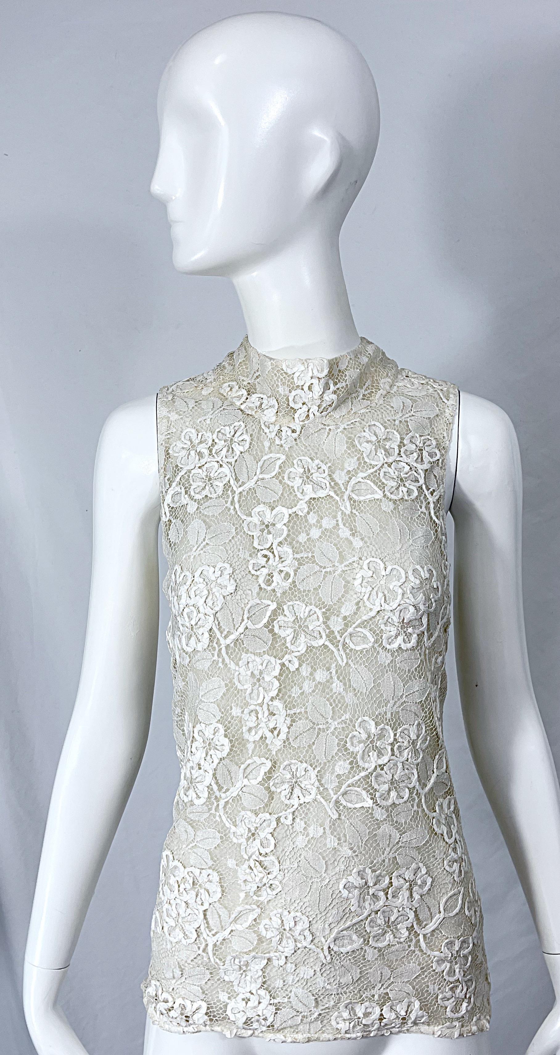 Beautiful vintage YVES SAINT LAURENT Rive Gauche YSL white Belgium lace sleeveless blouse! Features hand embroidered silk lace. Semi sheer white chiffon lining. Three white buttons up the back neck. 
Perfect for any day or evening event. Pair with