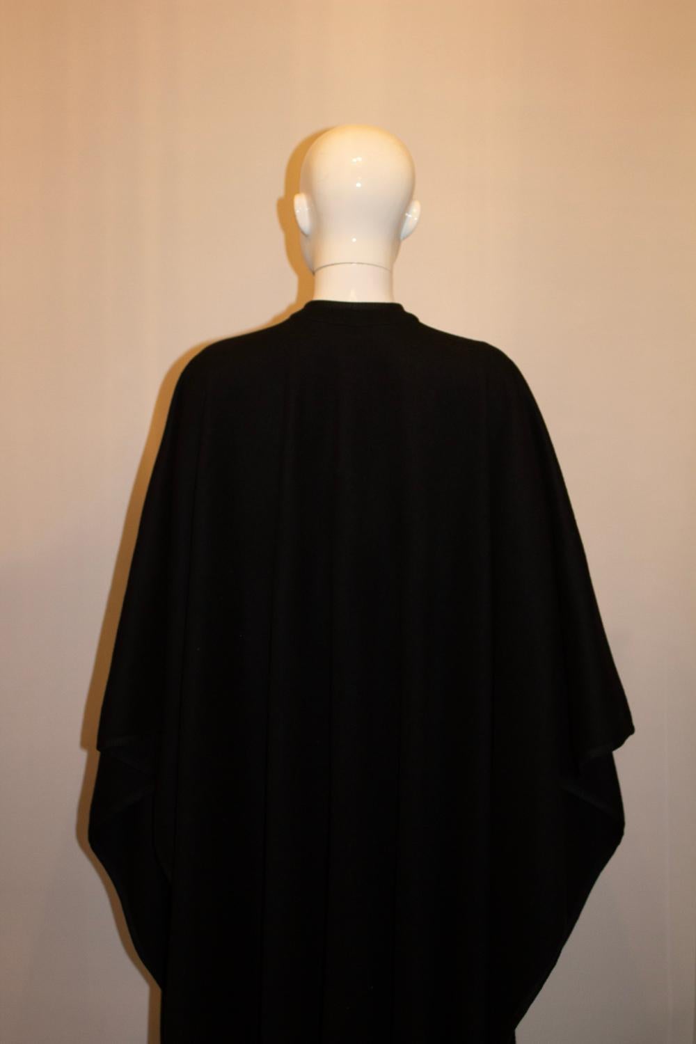 A stunning vintage cape by Yves Saint Laurent possibly from the Russian collection. 
In a black wool , with beautiful braid detail and all the original buttons. The cape can be worn with a belt for more definition. 
Size 40 Measurements: Bust up to