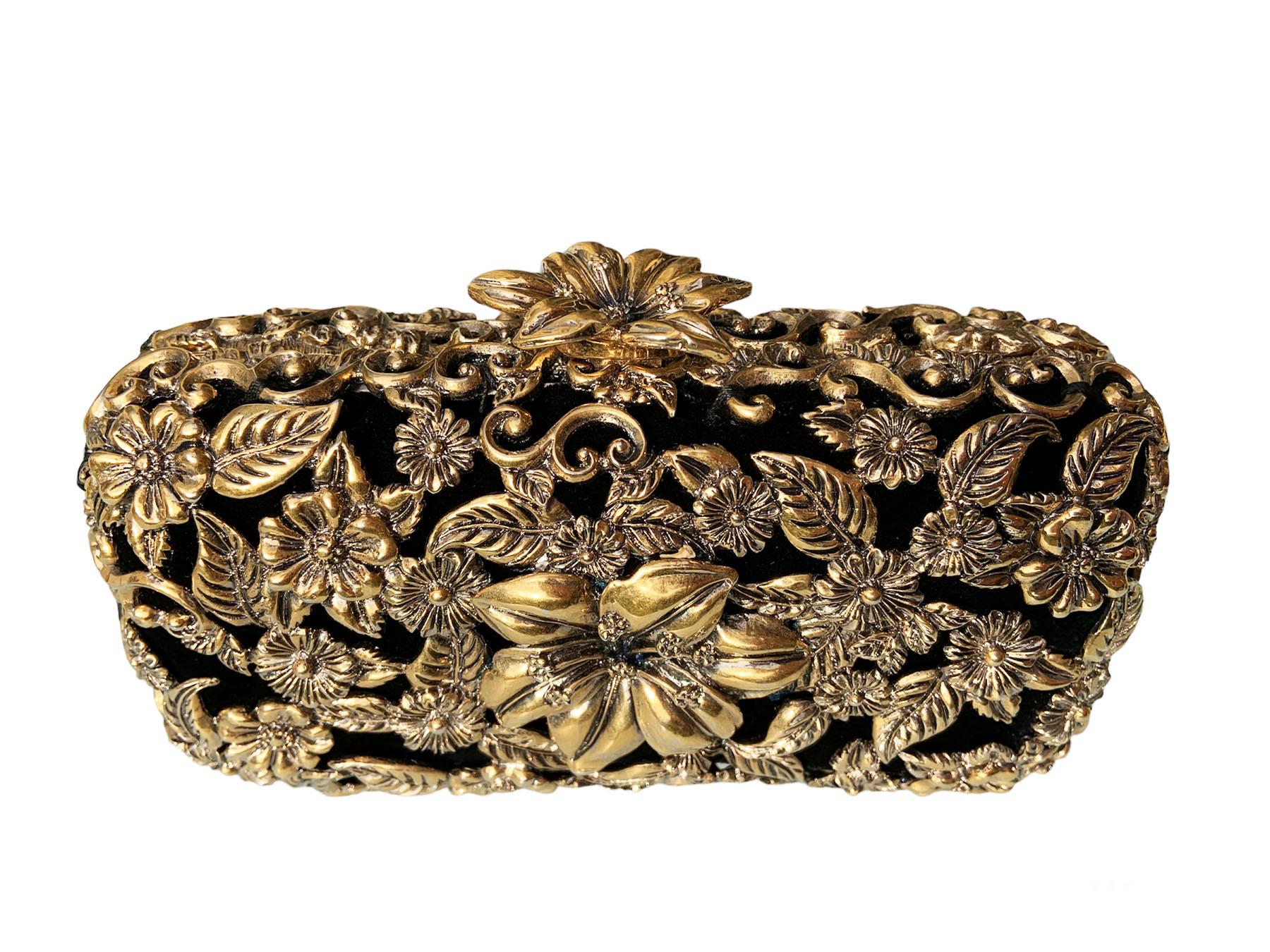 Vintage Yves Saint Laurent Rive Gauche Gold Tone Metal Clutch
Limited Edition  
Amazing Hand-Crafted Gold Tone Metal Frame with Flowers and Scrolls over the Black Velour, Adorned from Both Sides. 
Lift lock closure with 3-D Flower.  Black Velour