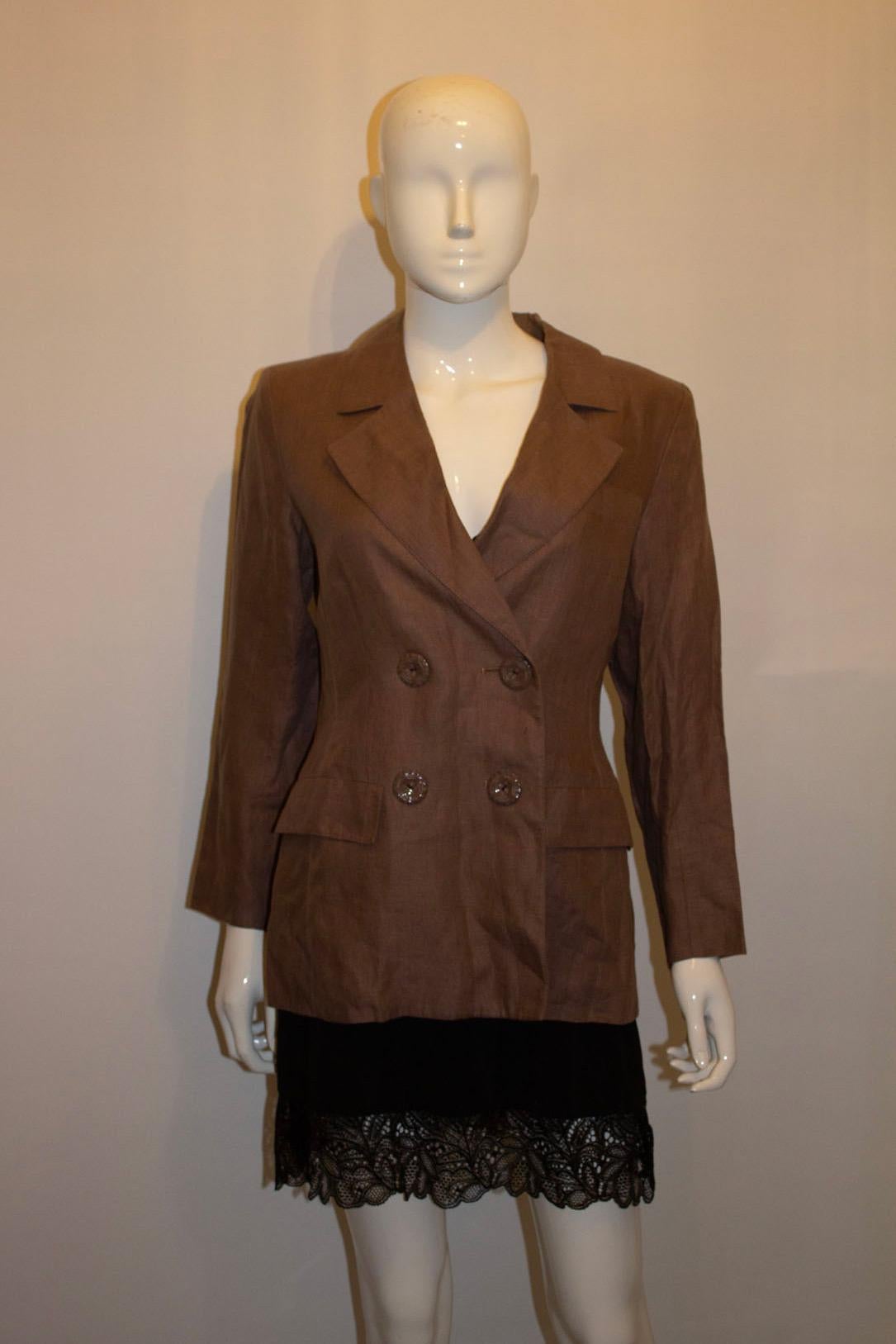 A fun vintage jacket by Yves Saint Laurent Rive Gauche ( main line). The jacket dates from 1996 ,  is in brown linen and is double breasted. It has a four button front opening and three button cuffs. It is fully lined and has two pockets. 
Size 36