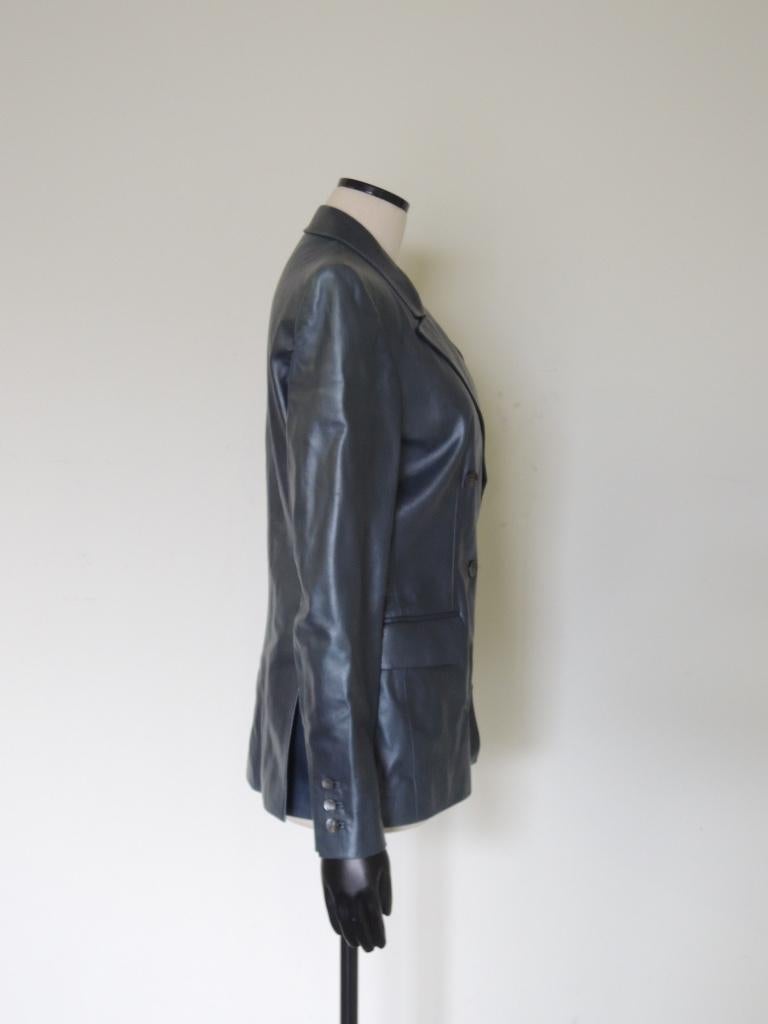 This is a vintage YSL Yves Saint Laurent Rive Gauche double-breasted blazer jacket in a soft, luxurious metallic blue/gray leather. Tuxedo-style peak lapels, functional 