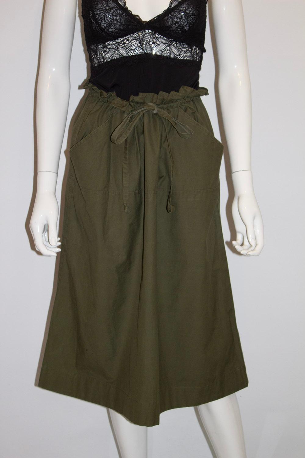 A great vintage skirt for Summer , by Yves Saint Laurent Rive Gauche . The skirt is in an attractive olive green colour with a drawstring waist / paper bag waist and 2 front pockets. It is unlined
Made in France Size 36. Measurements: waist up to