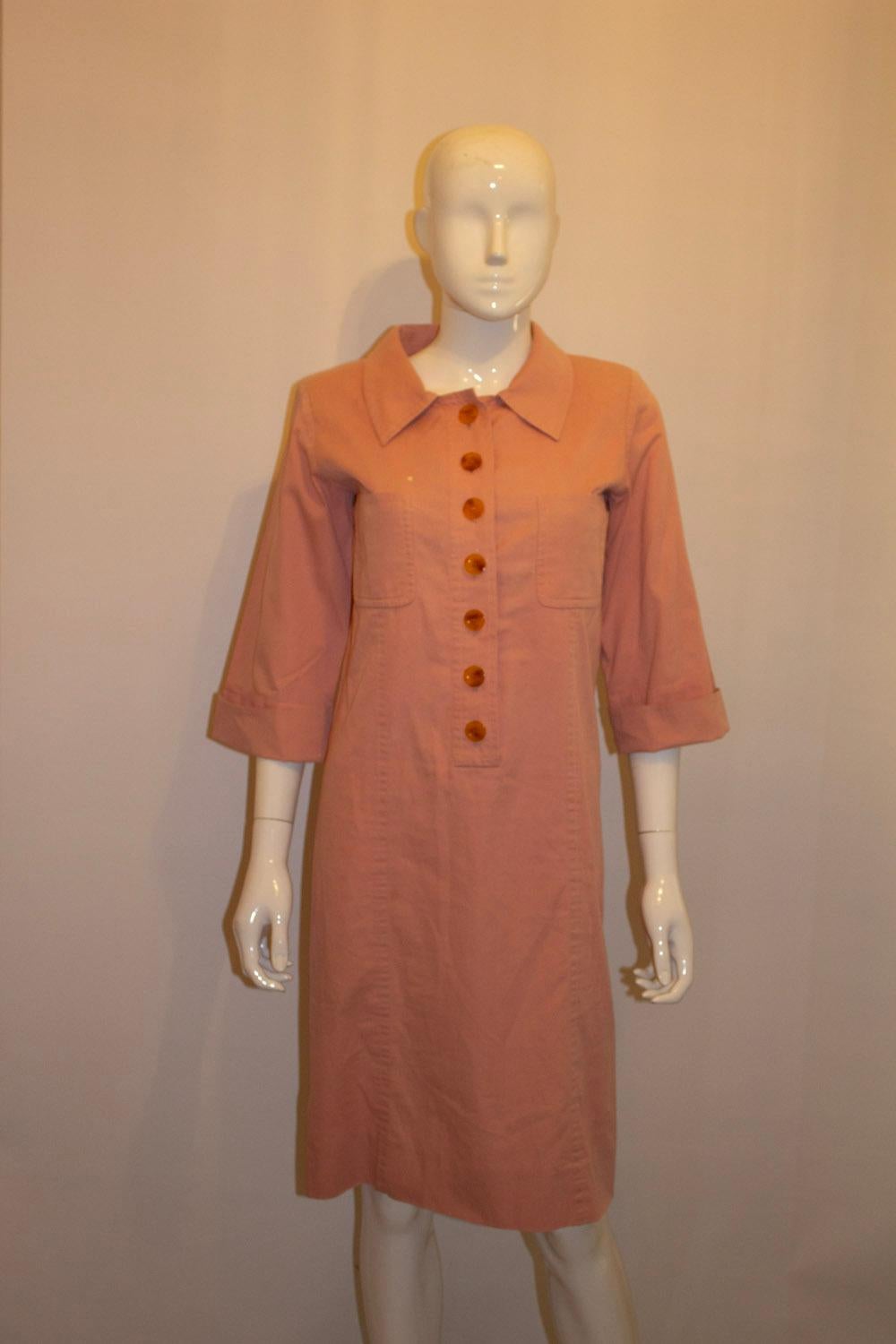 A pretty and easy to wear  vintage sping /summer dress from Yves Saint Laurent Rive Gauche. In a pretty pink cotton the dress has two breast pockets, and button front opening. It is unlined.
Size 36  Measurements: Bust 34'', length 39''
