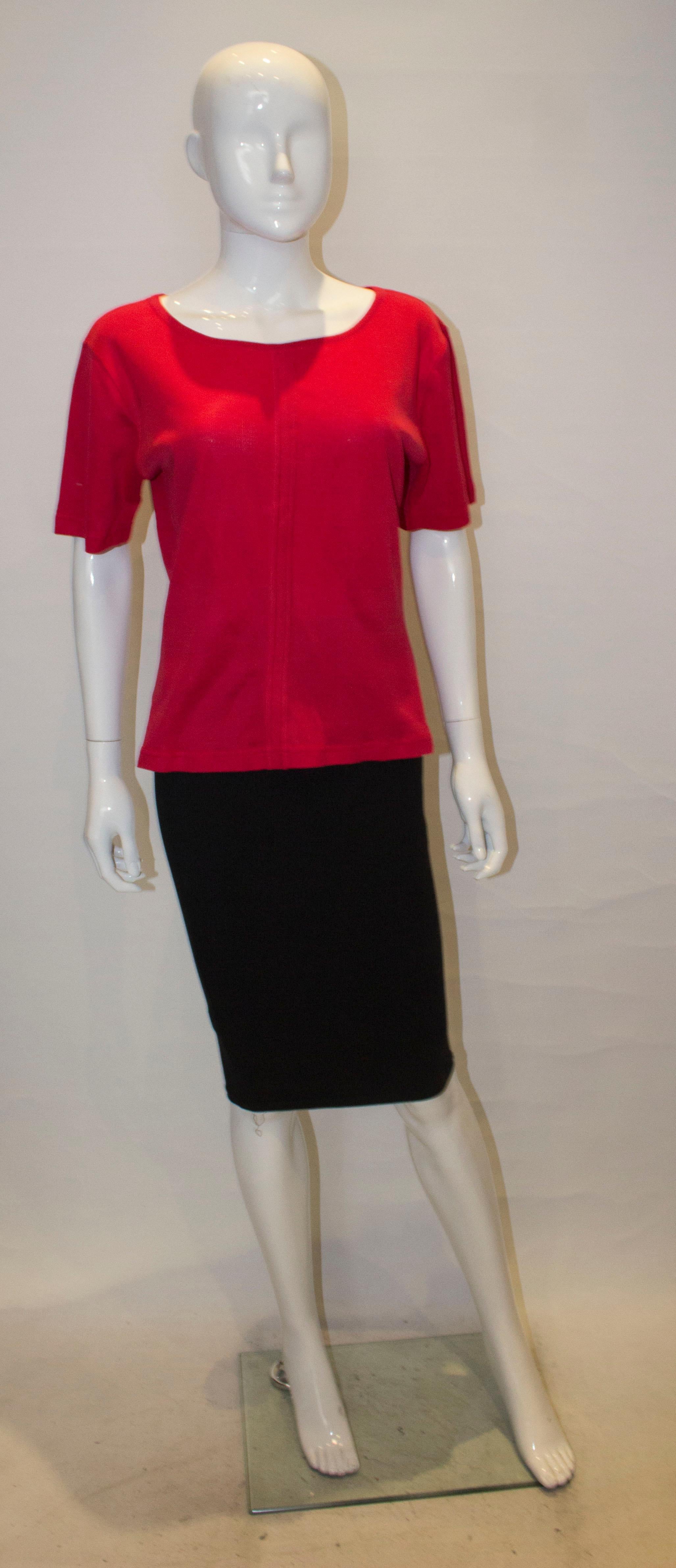 A chic abnd easy to wear vintage top by Yves Saint Laurent Rive Gauche line. The top has a round neckline and seam detail on the front.