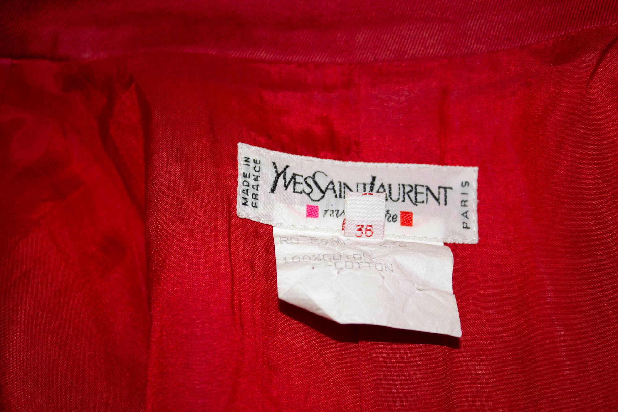 A chic vintage jacket by Yves Saint Laurent Rive Gauche. The jacket dates from 1993 and is in red cotton with two front pockets and wonderful buttons on the front and cuffs. It is fully lined. 
Size 36 Measurements: Bust  37/38'', length 24''