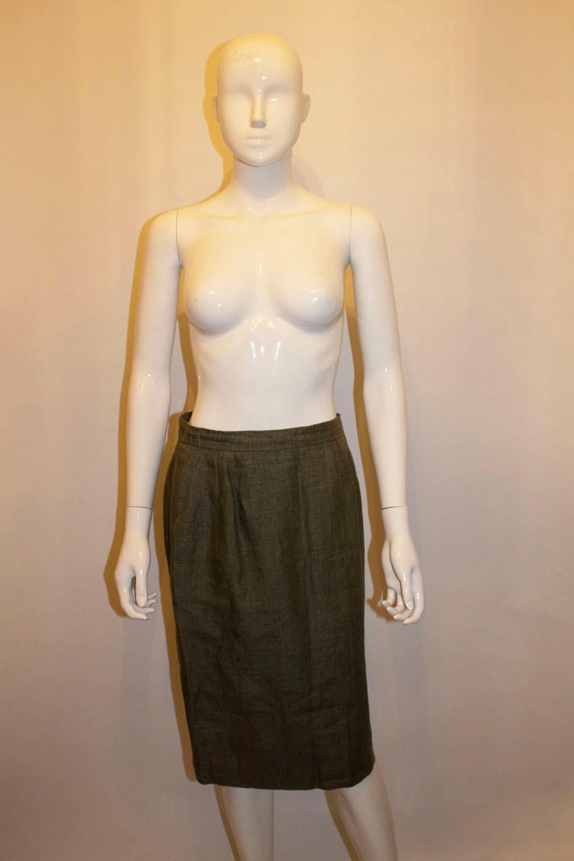 Perfect for Spring  or Summer, this pretty vintage skirt by Yves Saint Laurent ,Rive Gauche line. The linen skirt is in a sage green colour and has a side zip and two front pockets. The skirt is fully lined.
Size 40 measurements: waist 28'', length
