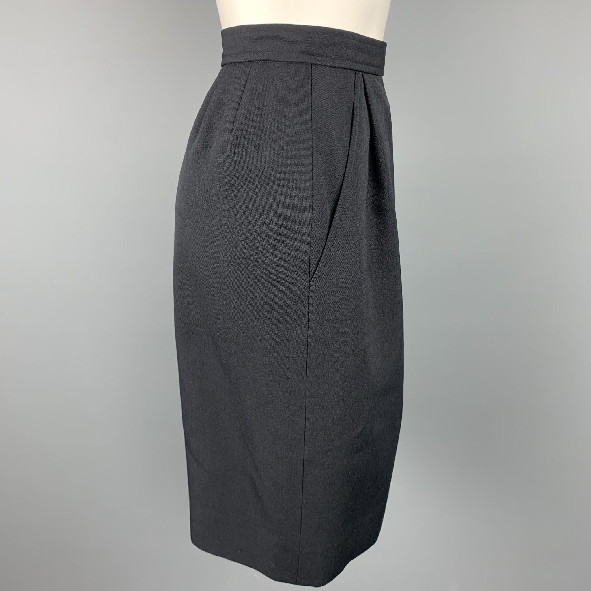 Vintage YVES SAINT LAURENT Rive Gauche skirt comes in a navy wool with a full liner featuring a pencil style, slit pockets, and a side button & zip up closure. Made in France.

Very Good Pre-Owned Condition.
Marked: 38

Measurements:

Waist: 27 in.