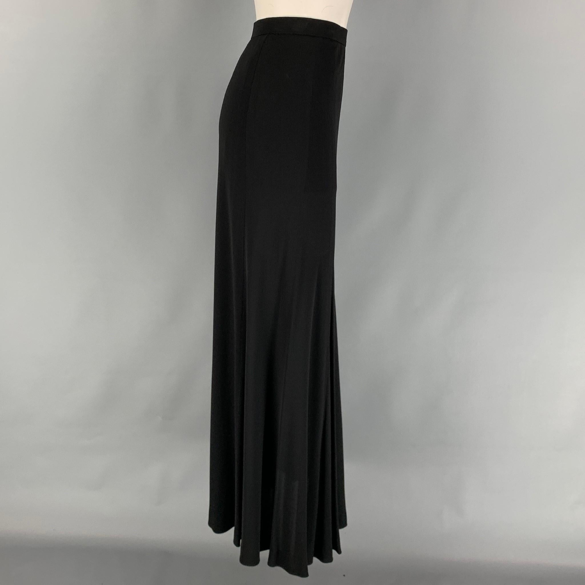 Vintage YVES SAINT LAURENT long skirt comes in a black viscose featuring a high waist and a side zipper closure. Made in France. 

Very Good Pre-Owned Condition.
Marked: 40

Measurements:

Waist: 28 in.
Hip: 34 in.
Length: 41 in. 