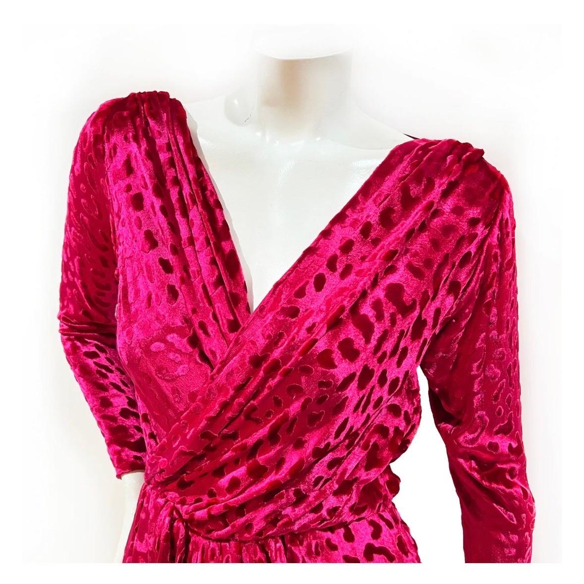 Velvet maxi dress by Saint Laurent Rive Gauche 
Circa 1980's
Made in France
Hot pink velvet 
Burnout leopard print throughout 
Long sleeved
Wrapped bodice 
Zipper slits on each cuff
Dual hip pockets
Side zip closure 
Velvet with silk blend