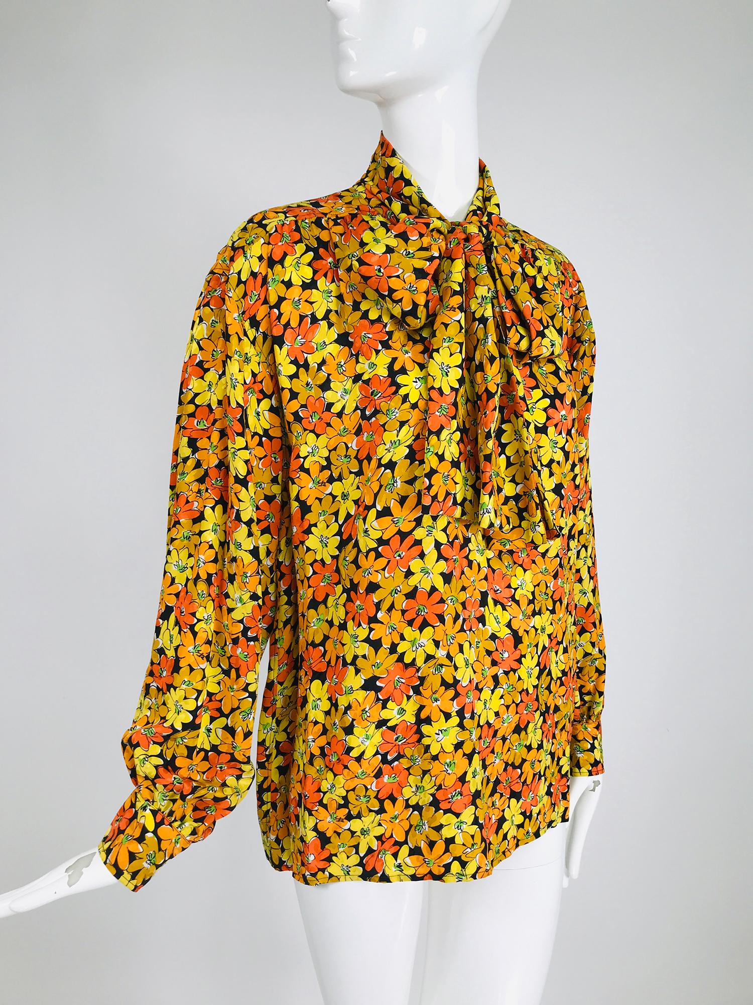 Vintage Yves Saint Laurent Rive Gauche vibrant floral silk print bow tie blouse. This beautiful silk blouse looks barely, if ever, worn. The print is bright and cheery. Pull on blouse has a button to the middle placket with attached ties at the