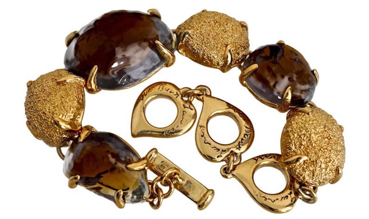 Vintage YVES SAINT LAURENT Robert Goossens Topaz Nugget Bracelet

Measurements:
Height: 6/8 inch ++ (close to 1 inch)
Wearable Length: 7 inches until 8 6/8 inches (adjustable)

Features:
- 100% Authentic YVES SAINT LAURENT.
- Irregular shaped poured