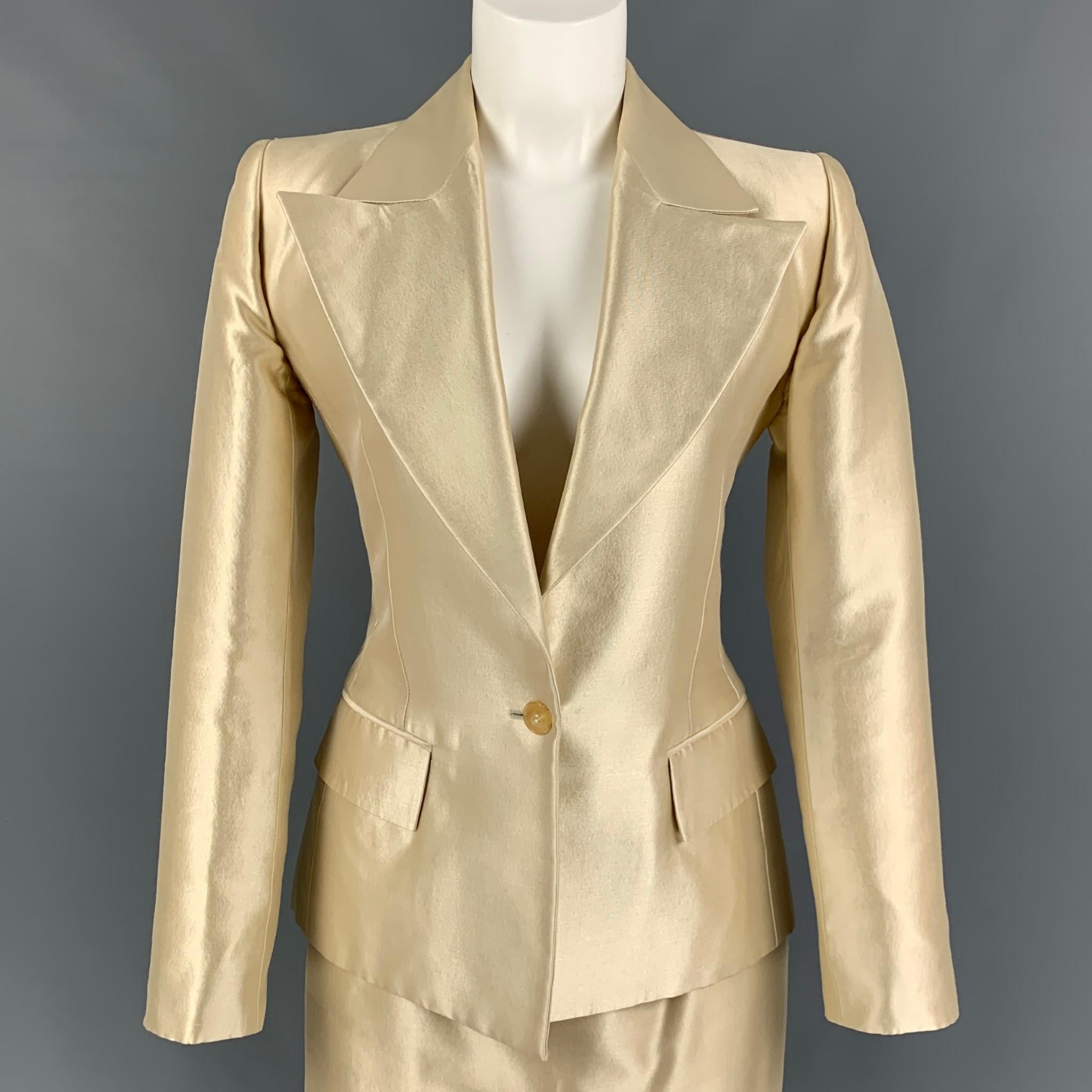 Vintage YVES SAINT LAURENT skirt suit comes in a cream wool / silk with a full liner featuring a large peak lapel, flap pockets, single back vent, single button closure, and a matching pencil skirt. Made in France. 

Very Good Pre-Owned Condition.