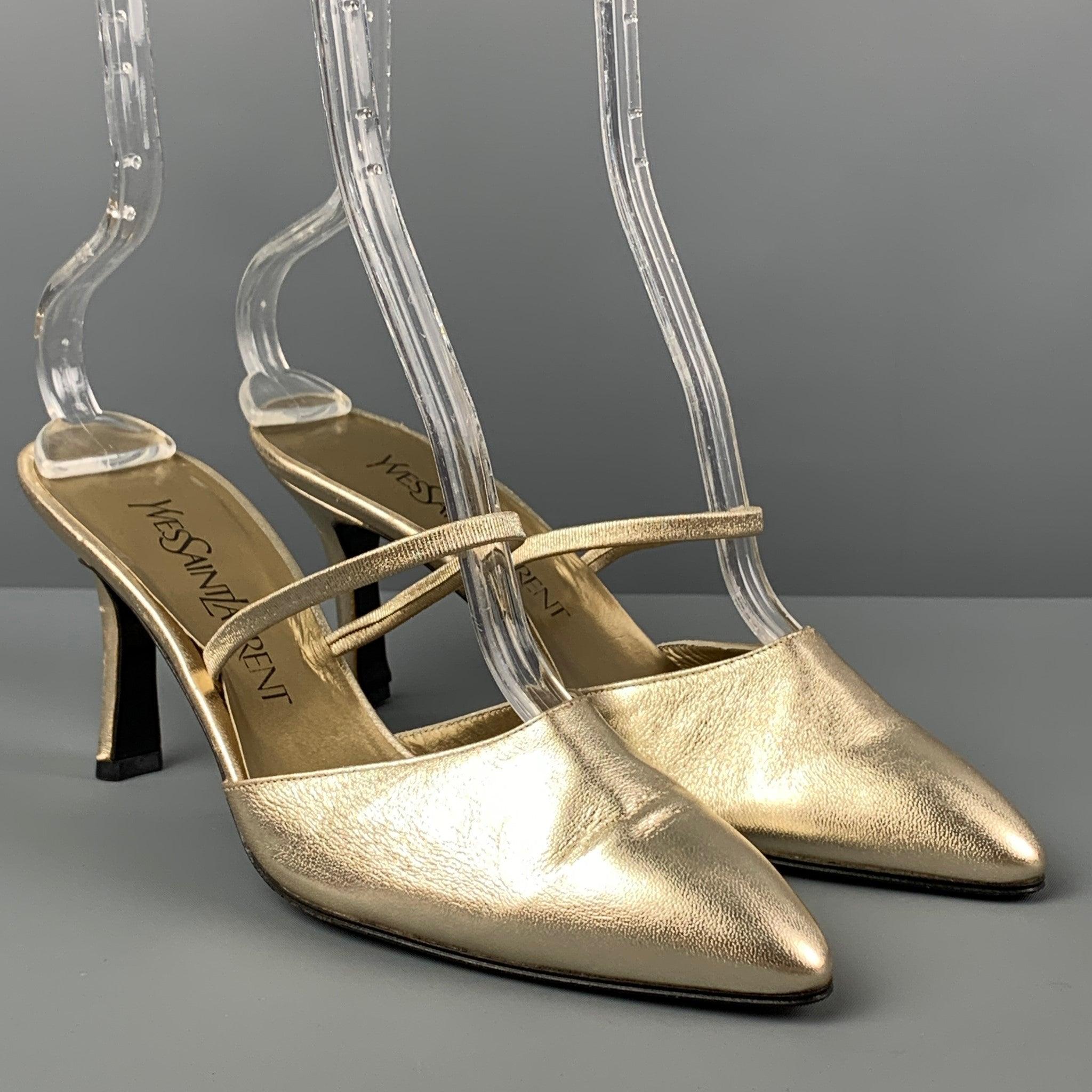Vintage YVES SAINT LAURENT heels comes in a gold metallic leather featuring a pointed toe, open back style, and a stacked heel. Made in Italy.
 Very Good
 Pre-Owned Condition. 
 

 Marked:  7.5 M  
 

 Measurements: 
  Heel: 3 inches 
  
  
  
 Sui