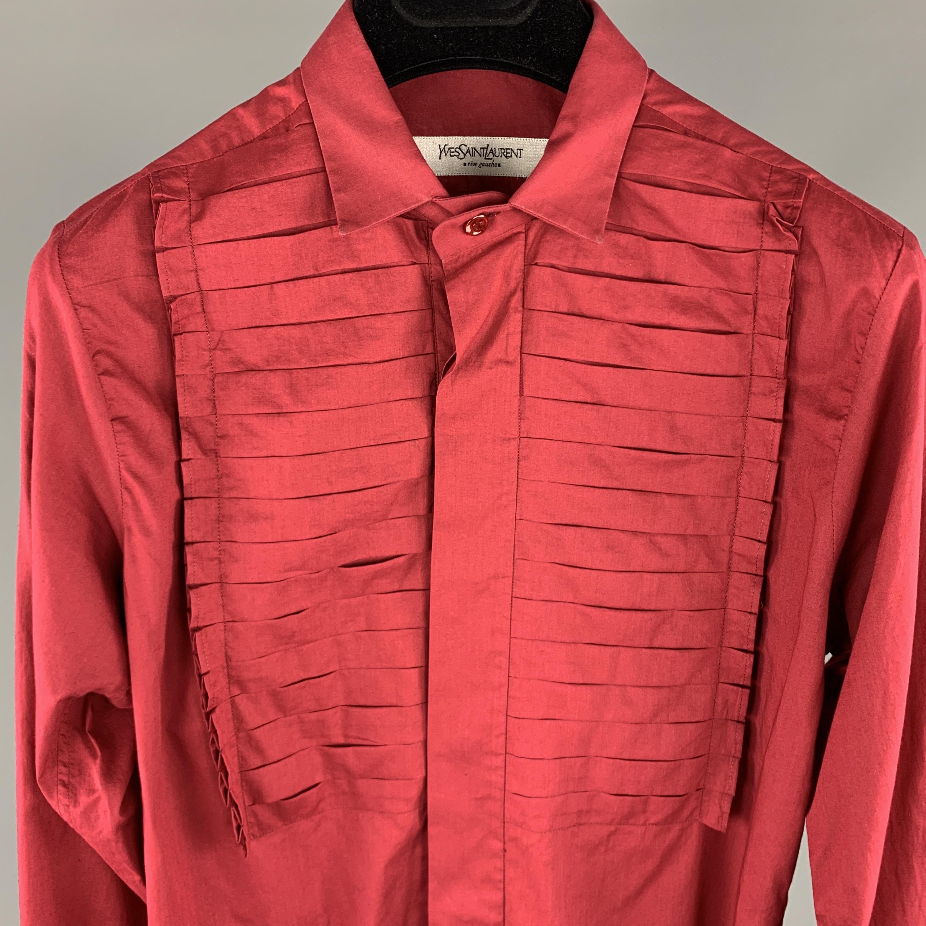 Vintage YVES SAINT LAURENT RIVE GAUCHE Long Sleeve Shirt comes in a burgundy tone in a solid cotton material, with a narrow collar, a pleated panel at front, French cuffs, hidden buttons at closure, button up. Made in Italy.

Very Good Pre-Owned