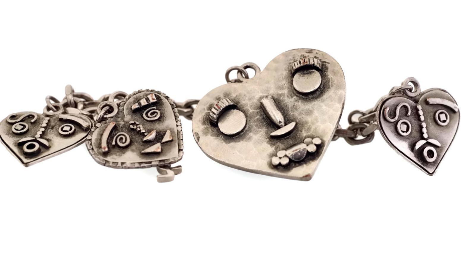 Vintage YVES SAINT LAURENT YSL Steampunk Heart Faces Charm Bracelet

Measurements:
Large Heart: 1 3/8 inches X 1 4/8 inches
Small Hearts: 8/8 inch X 9/8 inch
Length: 7 6/8 inches ( adjustable)

Features:
- 100% Authentic YVES SAINT LAURENT.
- 4