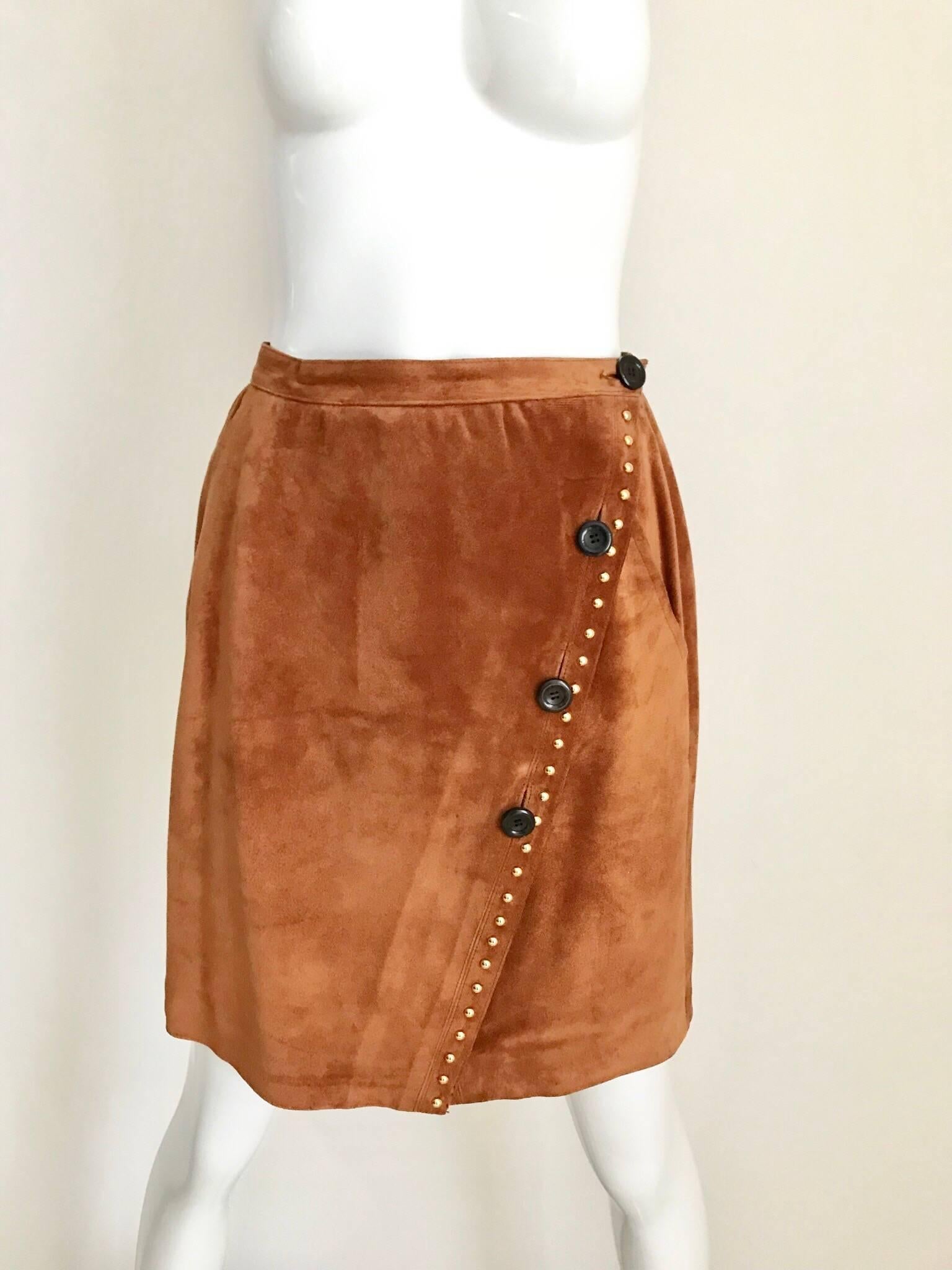 1980s Yves Saint Laurent Brown Suede Jacket and Skirt Set ensemble.
Wrap skirt with button. Jacket has large 4 pockets and shoulder pads.
Jacket measurement:  36 inches bust
Skirt measurement: 26 inches waist and 34 Hips