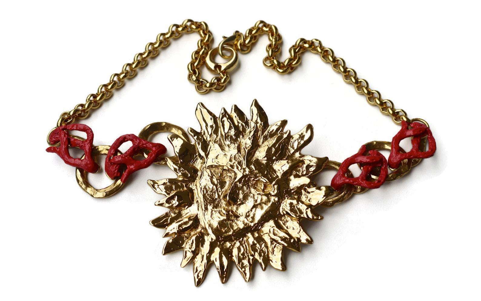 Vintage YVES SAINT LAURENT Sun Face Coral Necklace by Robert Goossens

Measurements:
Height: 8.5 cms
Width: 8 cms
Length: 57 cms 

This Vintage YVES SAINT LAURENT Sun Face Coral Necklace is RARE and such a collector item. This was designed by Robert