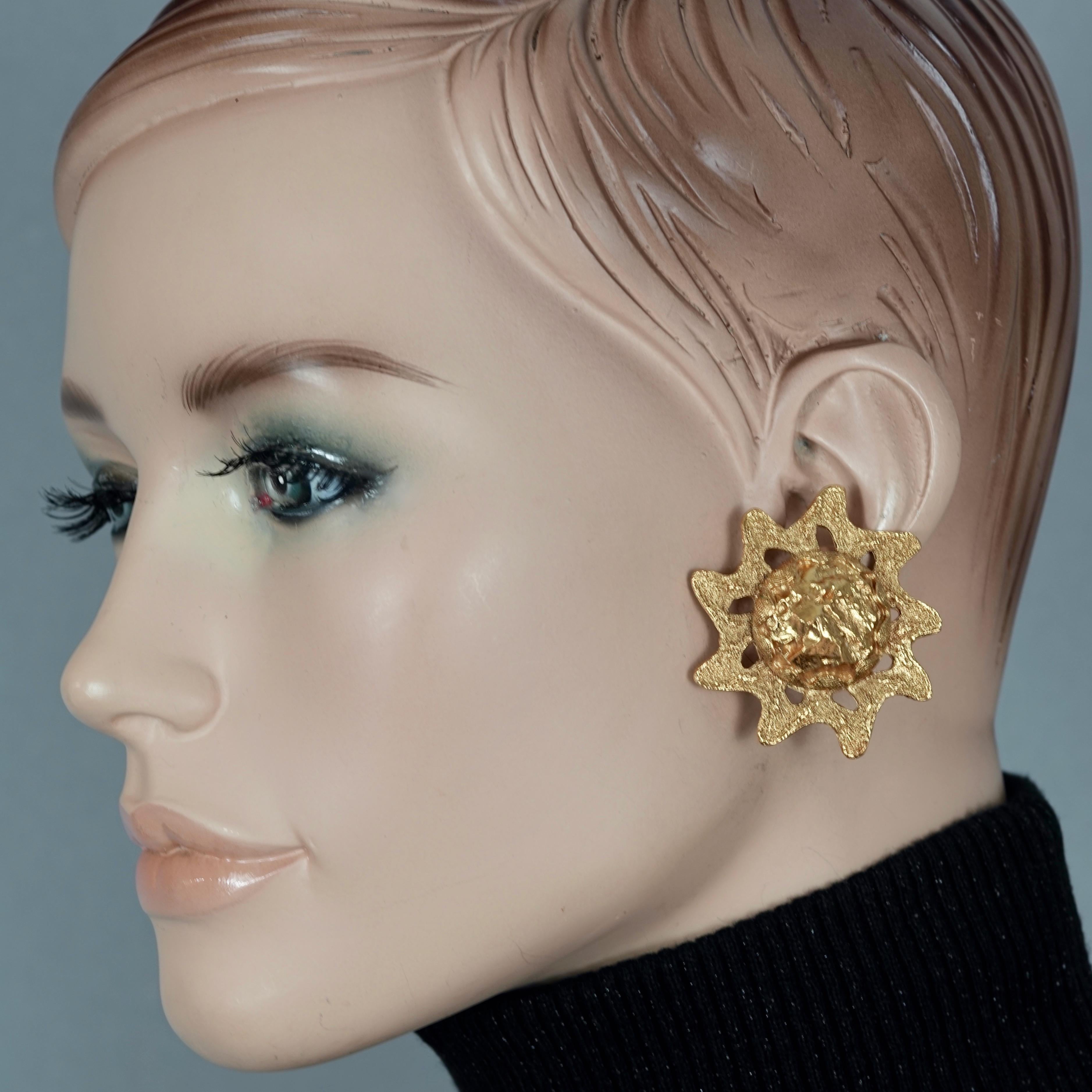 Vintage YVES SAINT LAURENT Sun Nugget by Robert Goossens Earrings

Measurements:
Height: 1.73 inches (4.4 cm)
Width: 1.73 inches (4.4 cm)
Weight per Earring: 19 grams

Features:
- 100% Authentic YVES SAINT LAURENT.
- Chunky sun with raised textured