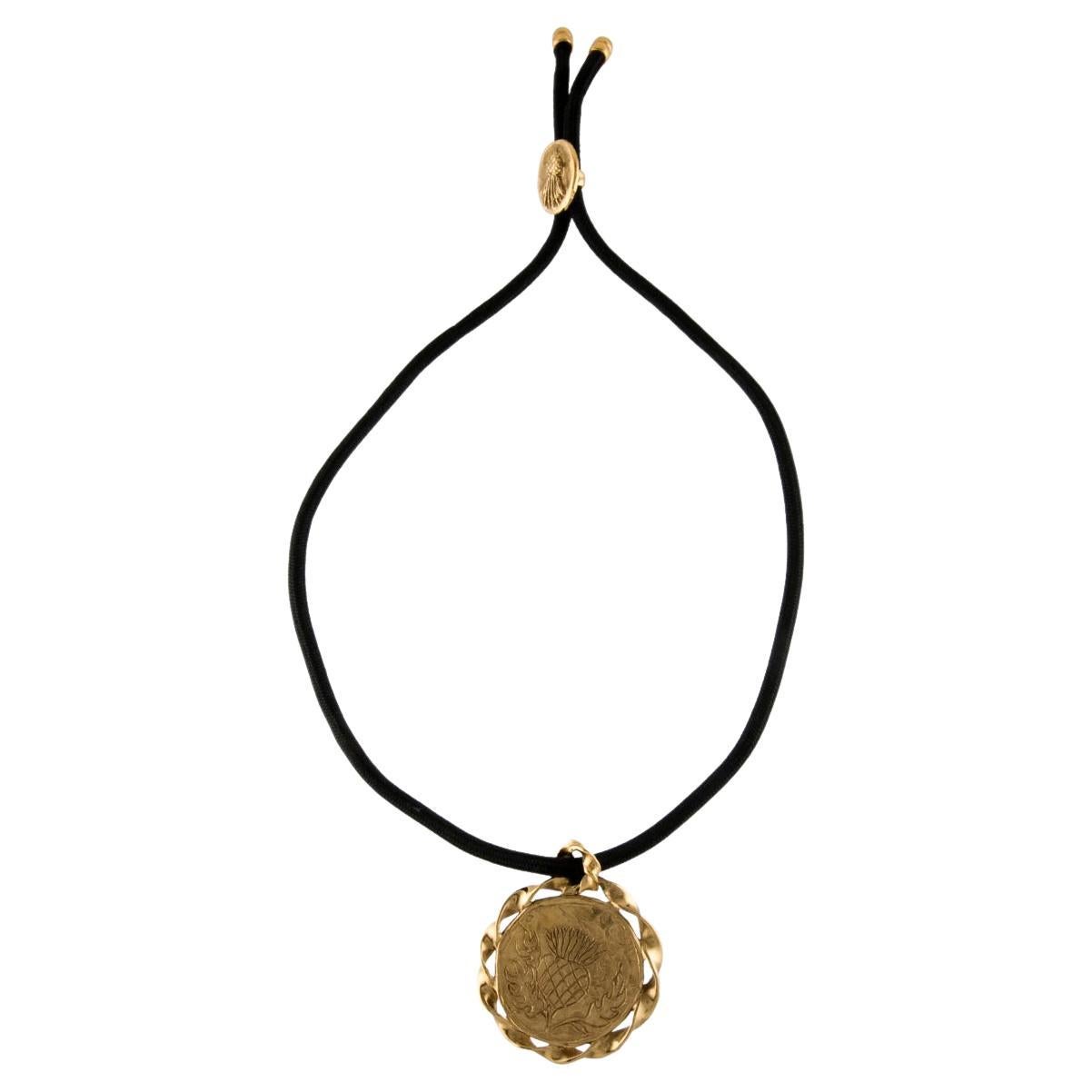 Yves Saint Laurent, collier pendentif médaillon en forme de chardon, années 1980