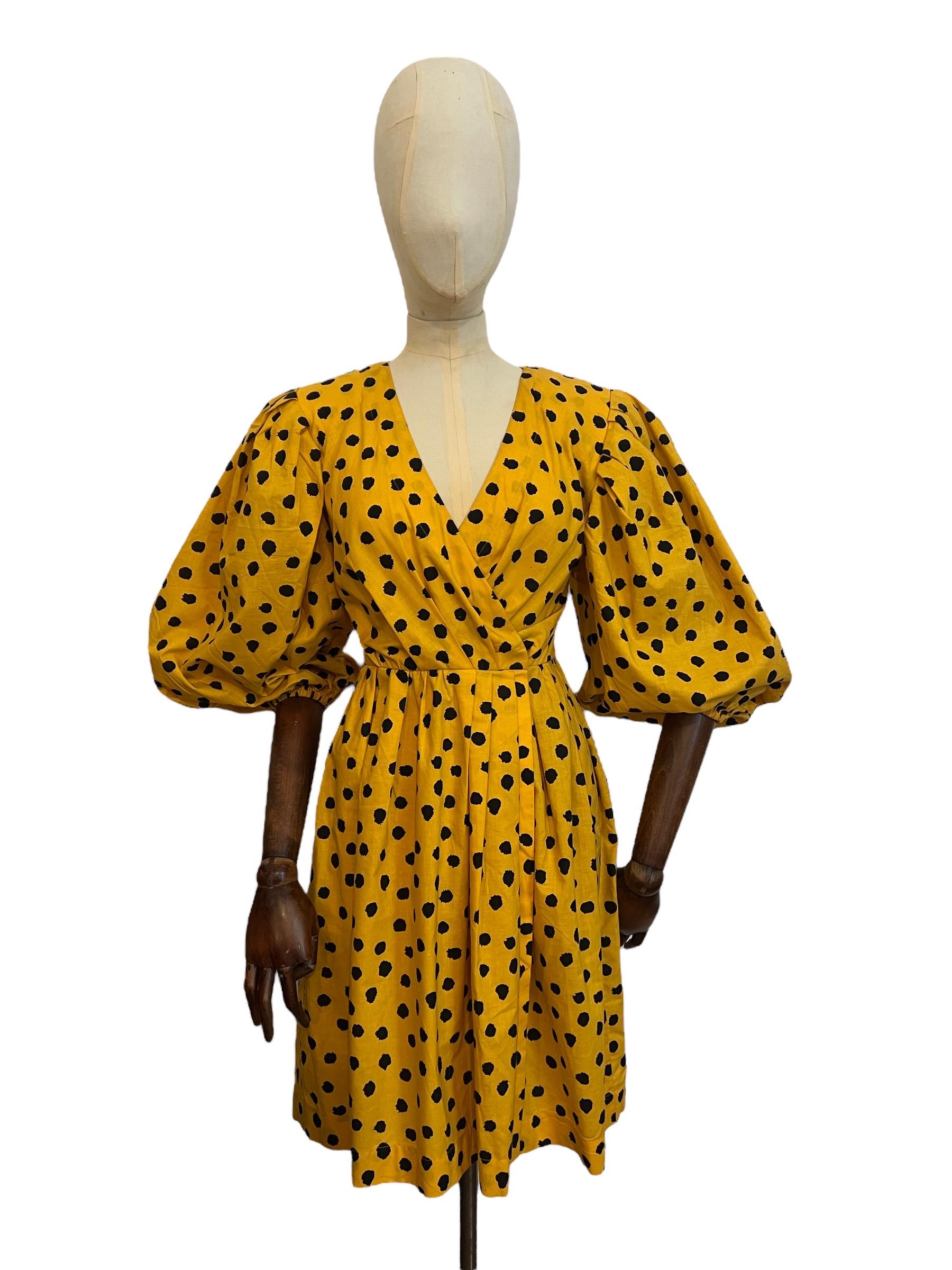 Beautiful Vintage Yves Saint Laurent 'Variation Rive Gauche' Dress circa 1980.

An Elegant cross over, deep V style dress, with a nipped waist, incredible balloon sleeves and relaxed slouchy hip pockets in Yellow with Black Paint like sploshes of