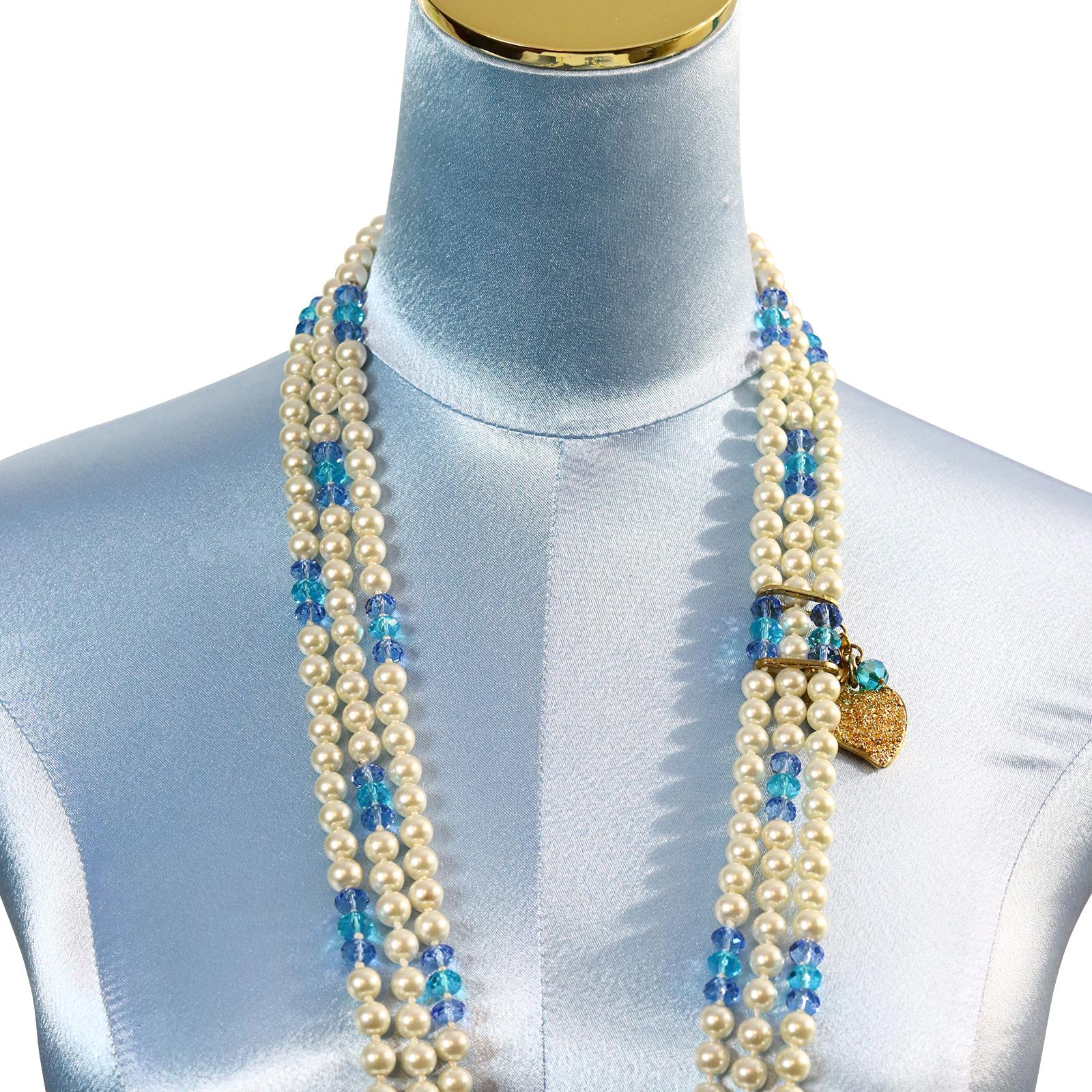 Vintage Yves Saint Laurent YSL 3 Strand Pearl and Blue Bead Necklace Circa 1990s.  Quite Different.  The Three Strands have 3 beads mixed in with the Pearls to Offset the Color. They are Held together by a Gold Dangling Heart in the Back signed by