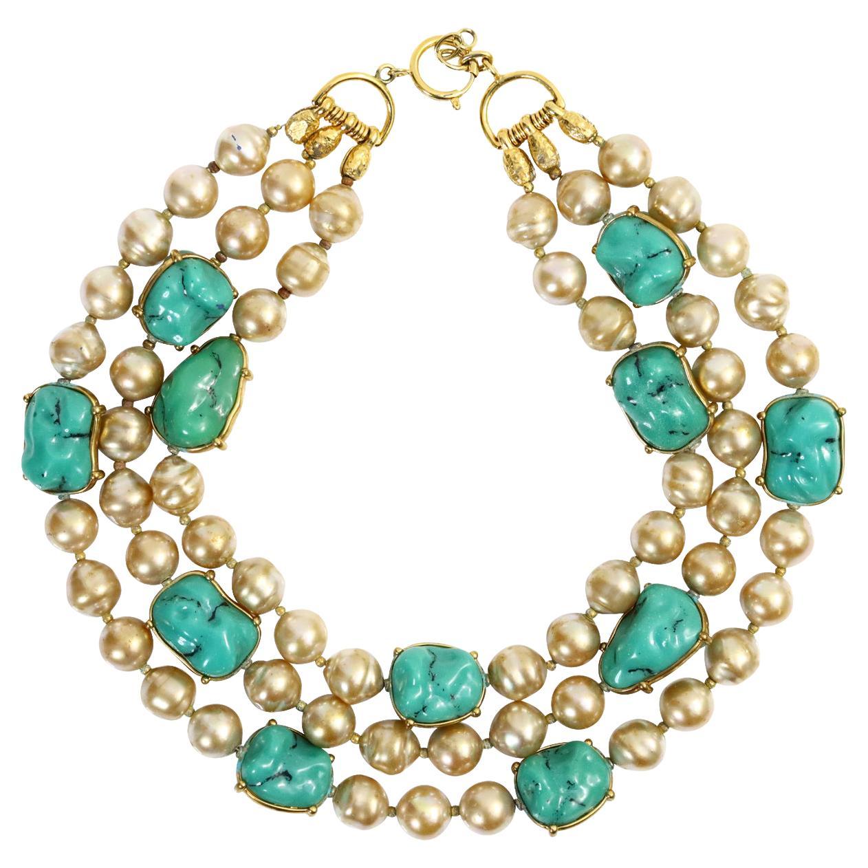 Vintage Yves Saint Laurent YSL 3 Strand Pearl and Faux Turquoise.  Not signed but attributed to Yves Saint Laurent.  The Pearls are all different Shapes and the Pieces of Faux Turquoise have been wrapped in Gold Metal.   This is not a new necklace