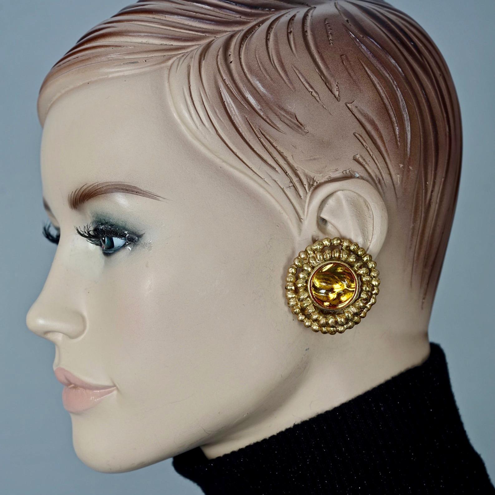 Vintage YVES SAINT LAURENT Ysl Amber Cabochon Disc Medallion Earrings

Measurements:
Height: 1.57 inches (4 cm)
Width: 1.49 inches (3.8 cm)
Weight per Earring: 18 grams

Features:
- 100% Authentic YVES SAINT LAURENT.
- Dramatic irregular depth