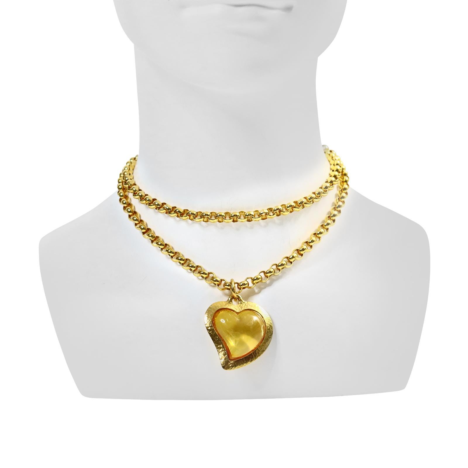 Vintage Yves Saint Laurent YSL Amber Resin Heart on Rollo Long Chain Circa 1980s.  The Heart is Surrounded by a Gold Tone piece that is Signed YSL. The Necklace is not.  The piece can be Long, Doubled worn as a lariat or worn tight against the neck
