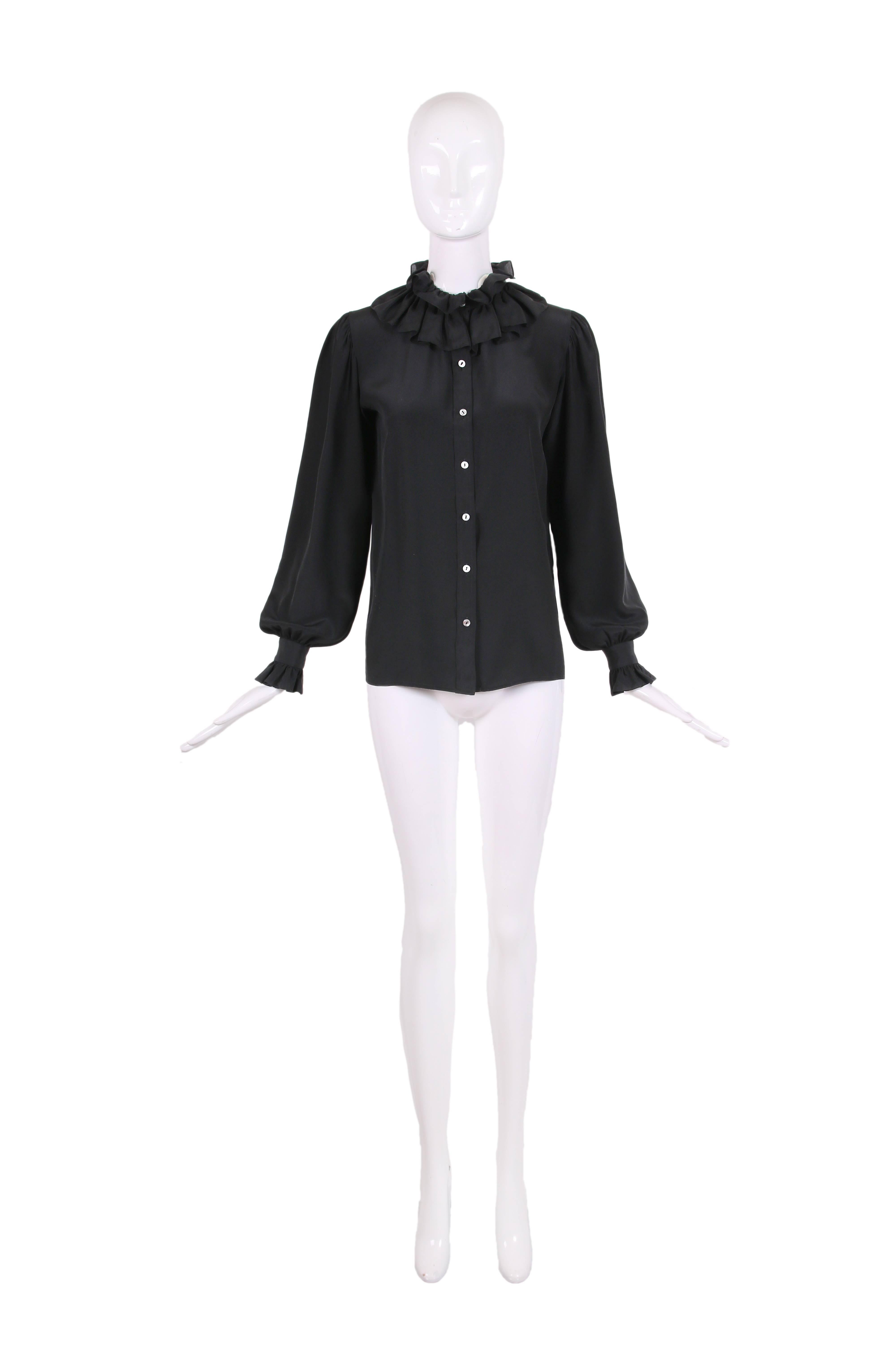 Vintage Yves Saint Laurent black silk blouse with buttons up the front and sleeve cuffs and ruffle trim at the neck and sleeves. In excellent condition.
MEASUREMENTS:
Shoulders - 14