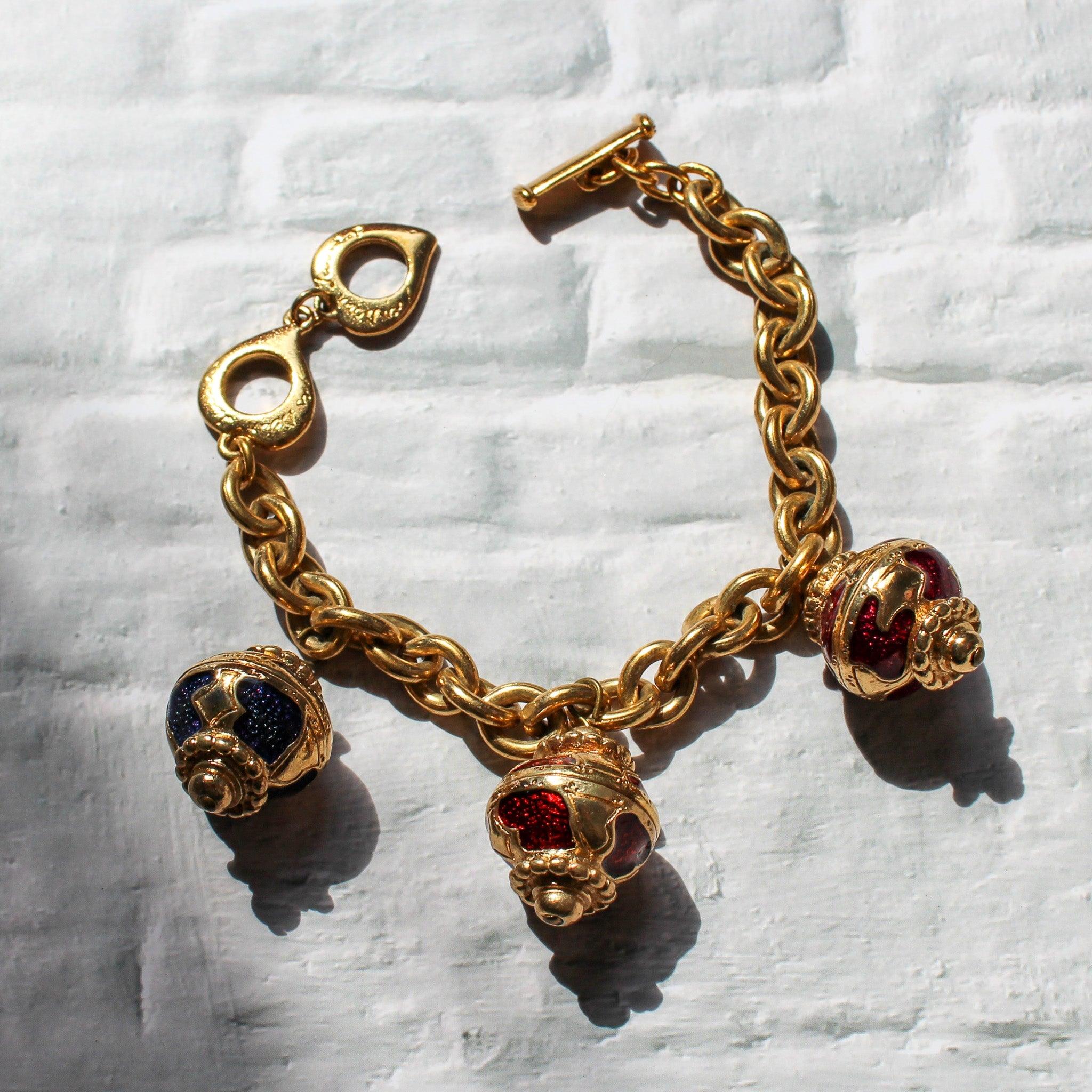 Vintage Yves Saint Laurent 1980s Charm Bracelet 
This YSL 1980s Vintage Charm Bracelet is more than just a beautiful accessory; it's a wearable work of art that pays homage to the unparalleled creativity and innovation of Yves Saint Laurent. 