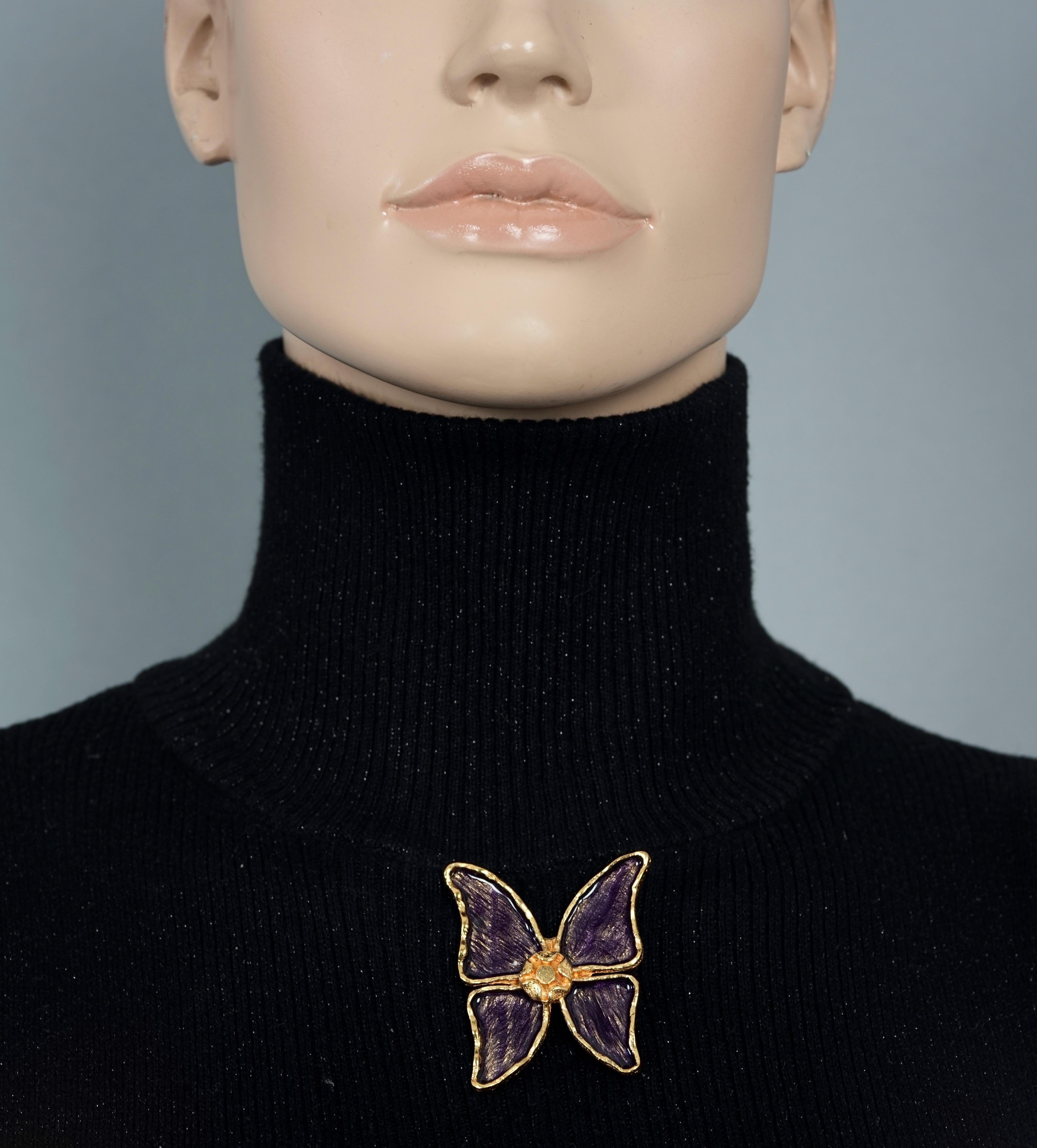 Vintage YVES SAINT LAURENT Ysl Butterfly Enamel Brooch

Measurements:
Height: 2 inches (5.08 cm)
Width: 1.75 inches (4.44 cm)

Features:
- 100% Authentic YVES SAINT LAURENT.
- Butterfly brooch in violet enamel.
- Gold tone hardware.
- Signed YSL