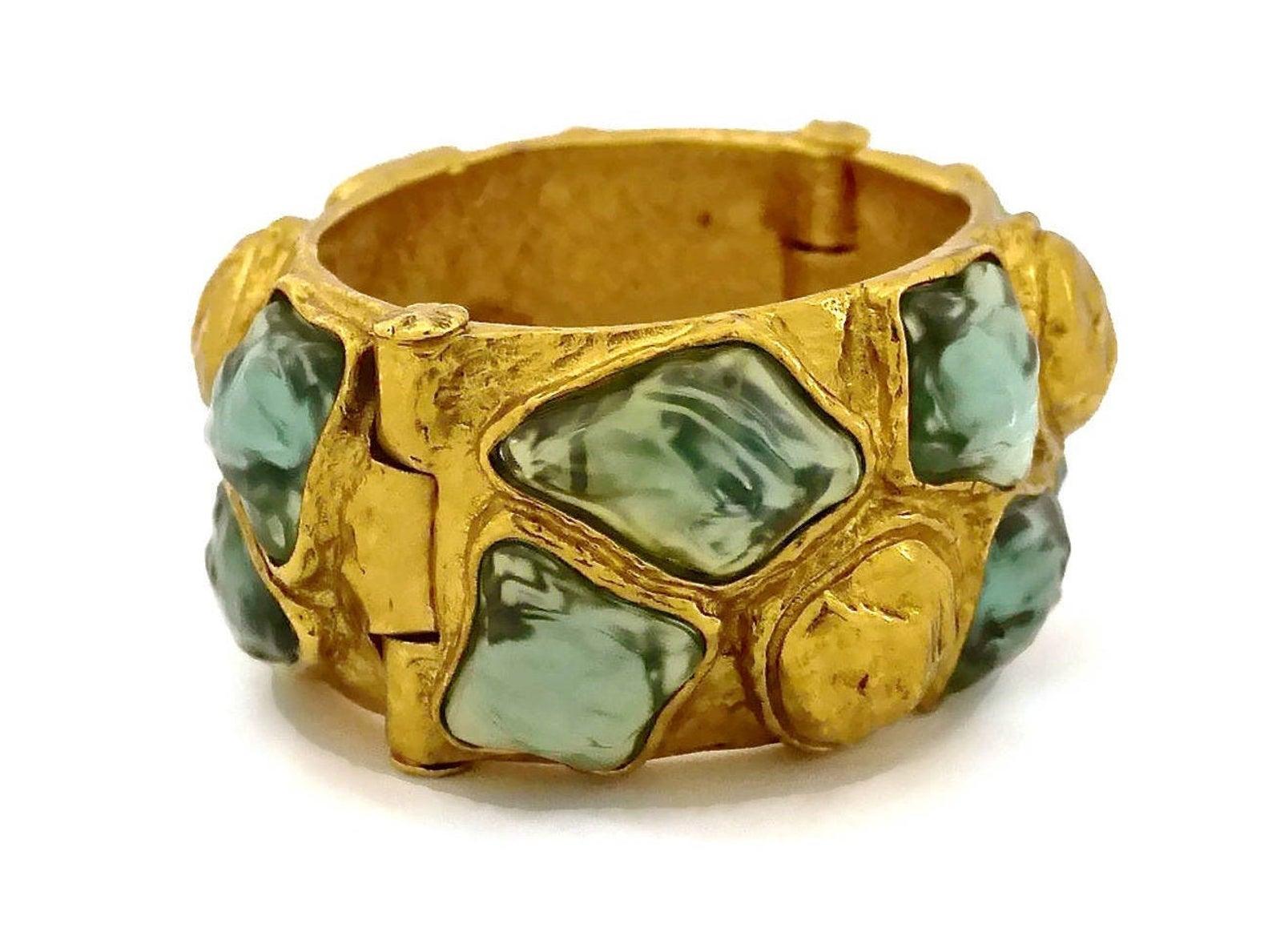 Vintage YVES SAINT LAURENT Ysl by Robert Goossens Cabochon Studded Cuff Bracelet

Measurements:
Height: 1.38 inches (3.5 cm)
Circumference: 6.45 inches (16.5 cm)
Thickness: 0.55 inch (1.4 cm)

Features:
- 100% Authentic YVES SAINT LAURENT by Robert