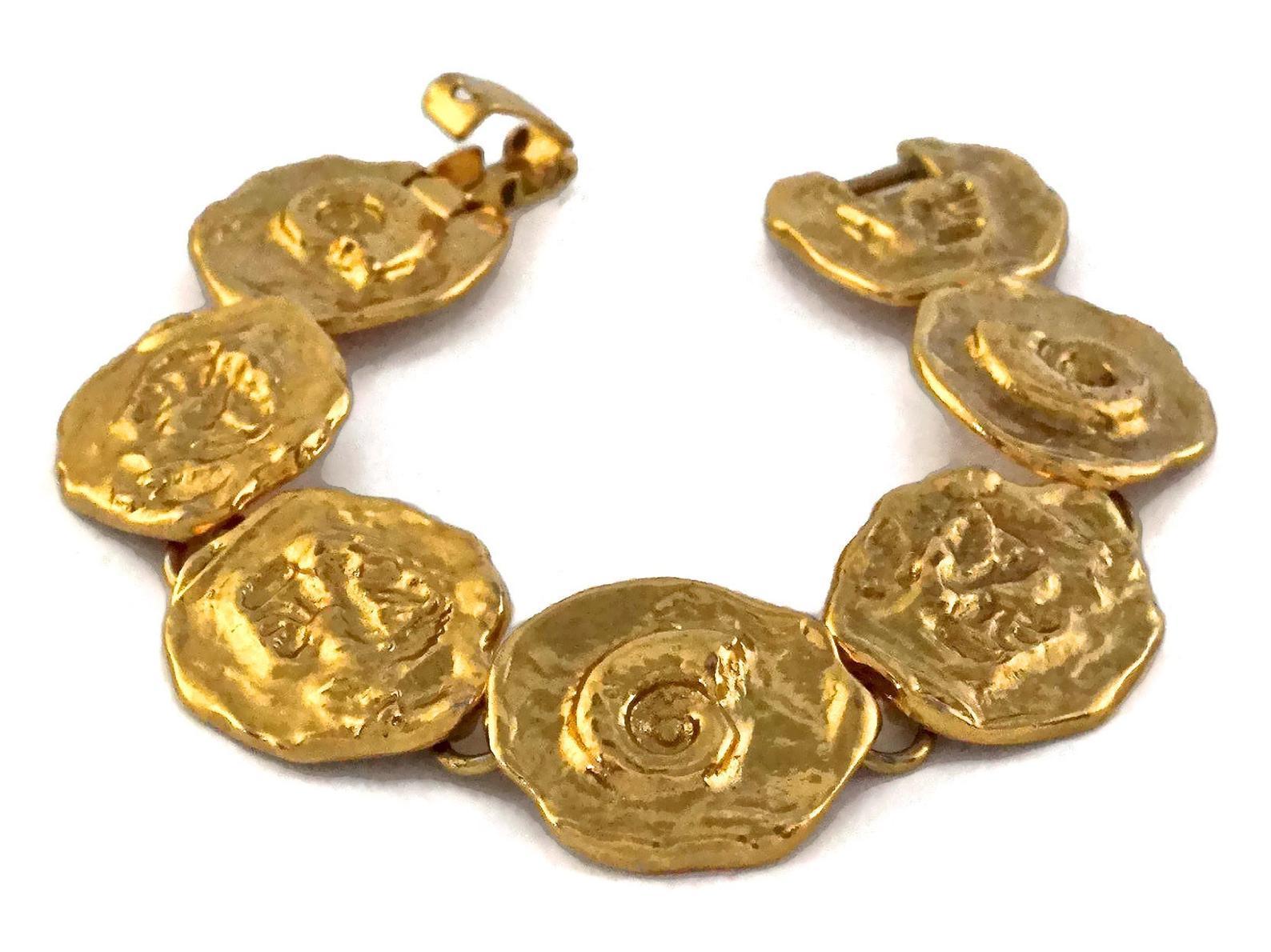Vintage YVES SAINT LAURENT Ysl by Robert Goossens Fossil Disc Bracelet

Measurements:
Height: 0.90 inch (2.3 cm)
Length: 7.67 inches (19.5 cm)

Features:
- 100% Authentic YVES SAINT LAURENT.
- Embossed fossil impression on every discs.
- Signed YSL