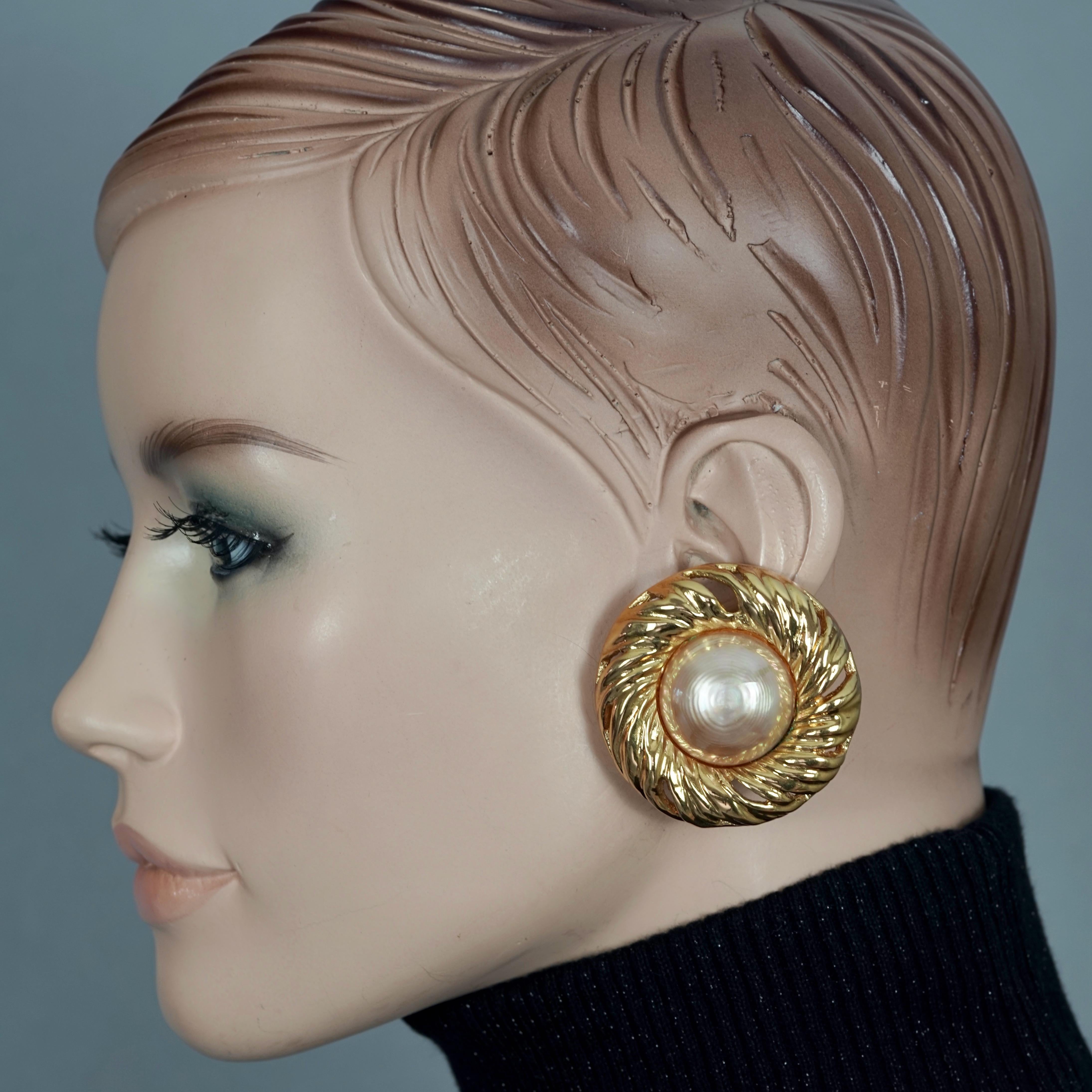 Vintage YVES SAINT LAURENT Ysl by Robert Goossens Pearl Swirl Disc Earrings

Measurements:
Height: 1.85 inches (4.7 cm)
Width: 1.85 inches (4.7 cm)
Weight per Earring: 28 grams

Features:
- 100% Authentic YVES SAINT LAURENT by Robert Goossens.
-