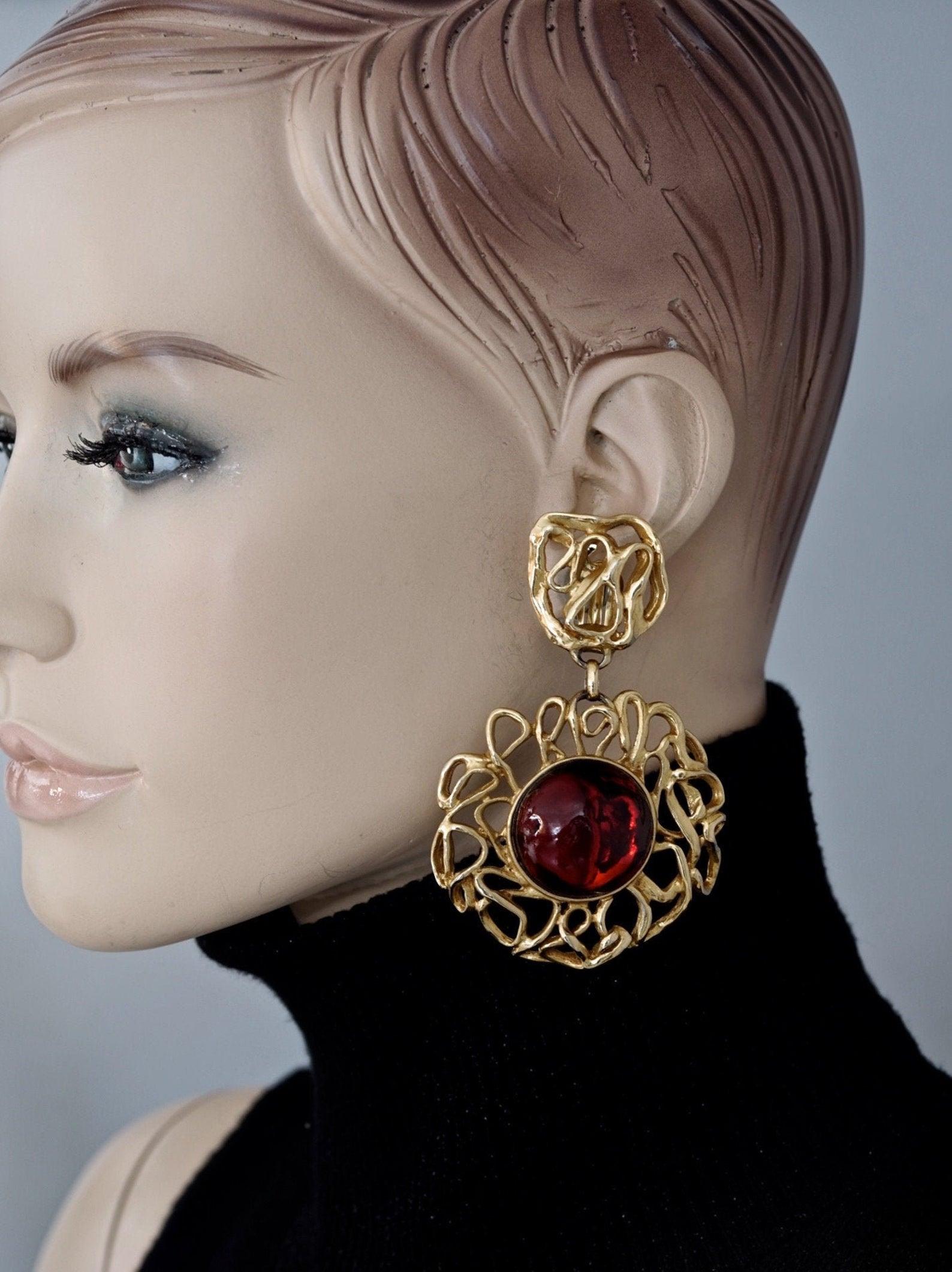Vintage YVES SAINT LAURENT Ysl by Robert Goossens Ruby Cabochon Wire Flower Dangling Earrings

Measurements:
Height: 3.42 inches (8.7 cm)
Width: 2.16 inches (5.5 cm)
Weight per Earring: 31 grams

Features:
- 100% Authentic YVES SAINT LARENT by