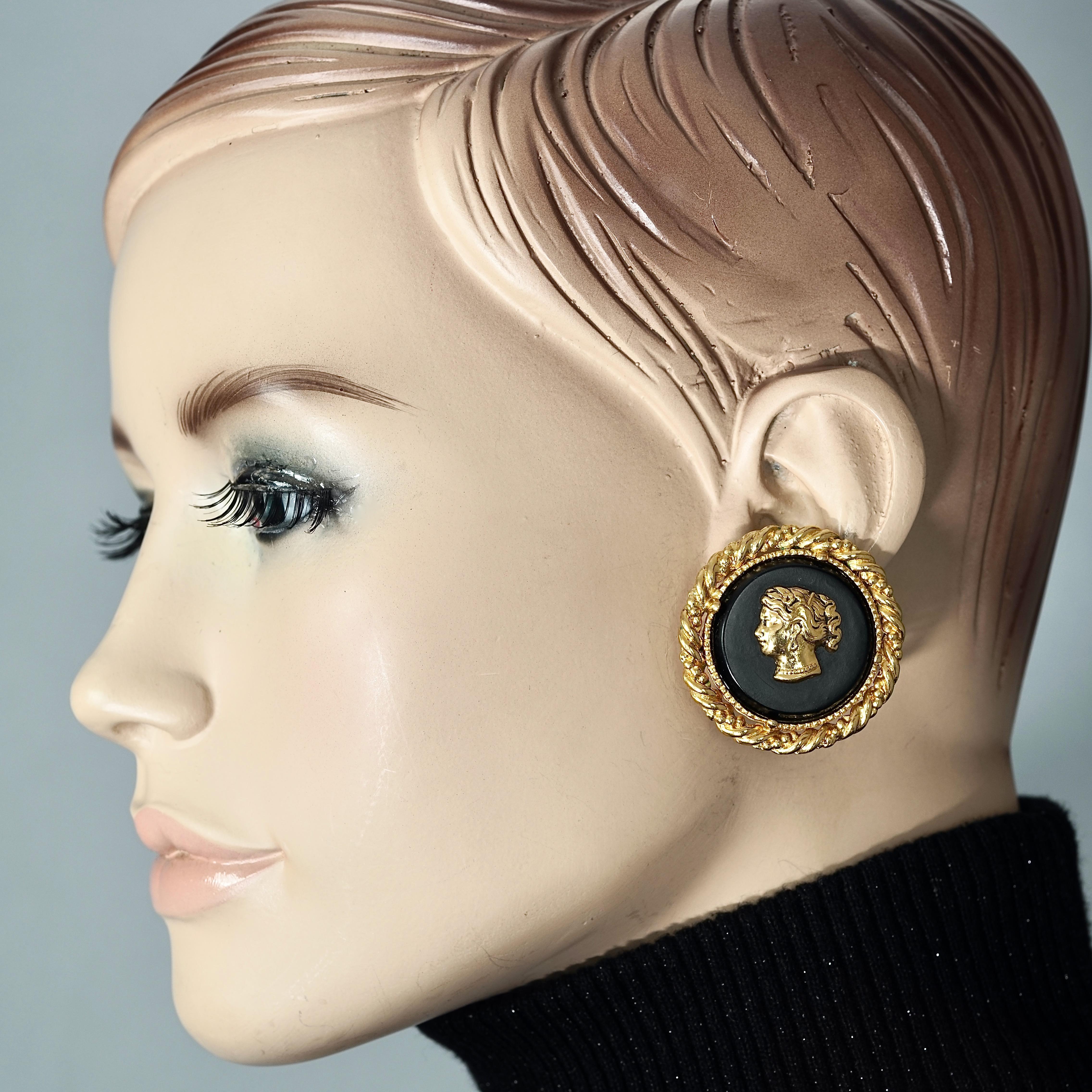 Vintage YVES SAINT LAURENT Ysl Cameo Lady Profile Earrings

Measurements:
Height: 1.57 inches (4 cm)
Width: 1.57 inches (4 cm)
Weight per Earring: 20 grams

Features:
- 100% Authentic YVES SAINT LAURENT.
- Raised metal lady cameo on black resin