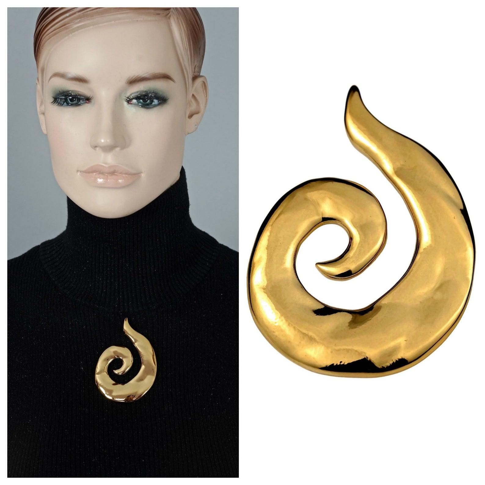 Vintage YVES SAINT LAURENT Ysl Coiled Spiral Brooch

Measurements:
Height: 3.03 inches (7.7 cm)
Width: 5.4 inches (5.4 cm)

Features:
- 100% Authentic YVES SAINT LAURENT.
- Coiled spiral hammered gilt brooch.
- Gold tone.
- Signed YSL Made in