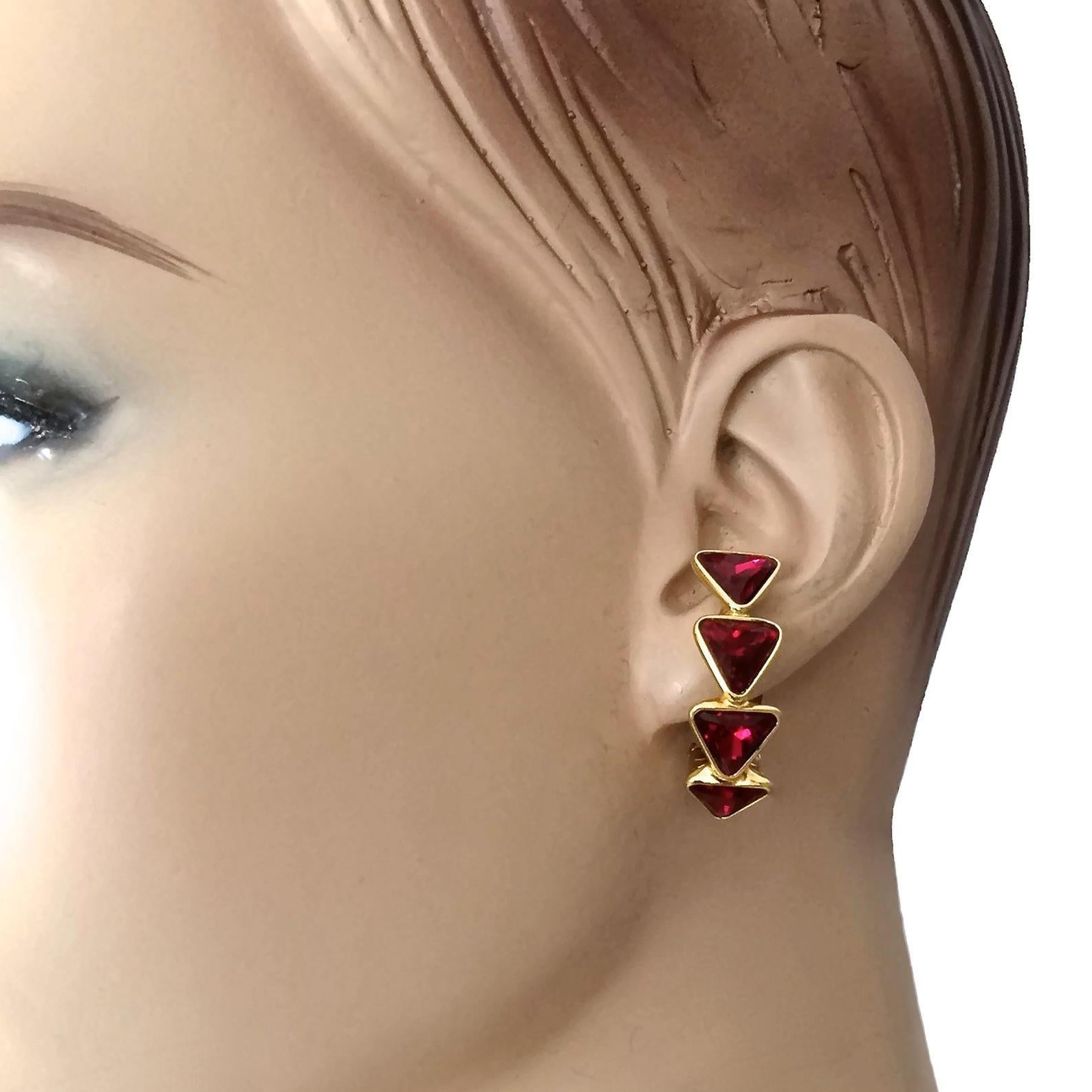 Vintage YVES SAINT LAURENT Ysl Geometric Ruby Rhinestone Earrings

Measurements:
Height: 1.29 inches (3.3 cm)
Width: 0.39 inch (1 cm)
Weight: 7 grams

Features:
- 100% Authentic YVES SAINT LAURENT.
- Geometric triangle ruby rhinestones.
- Gold