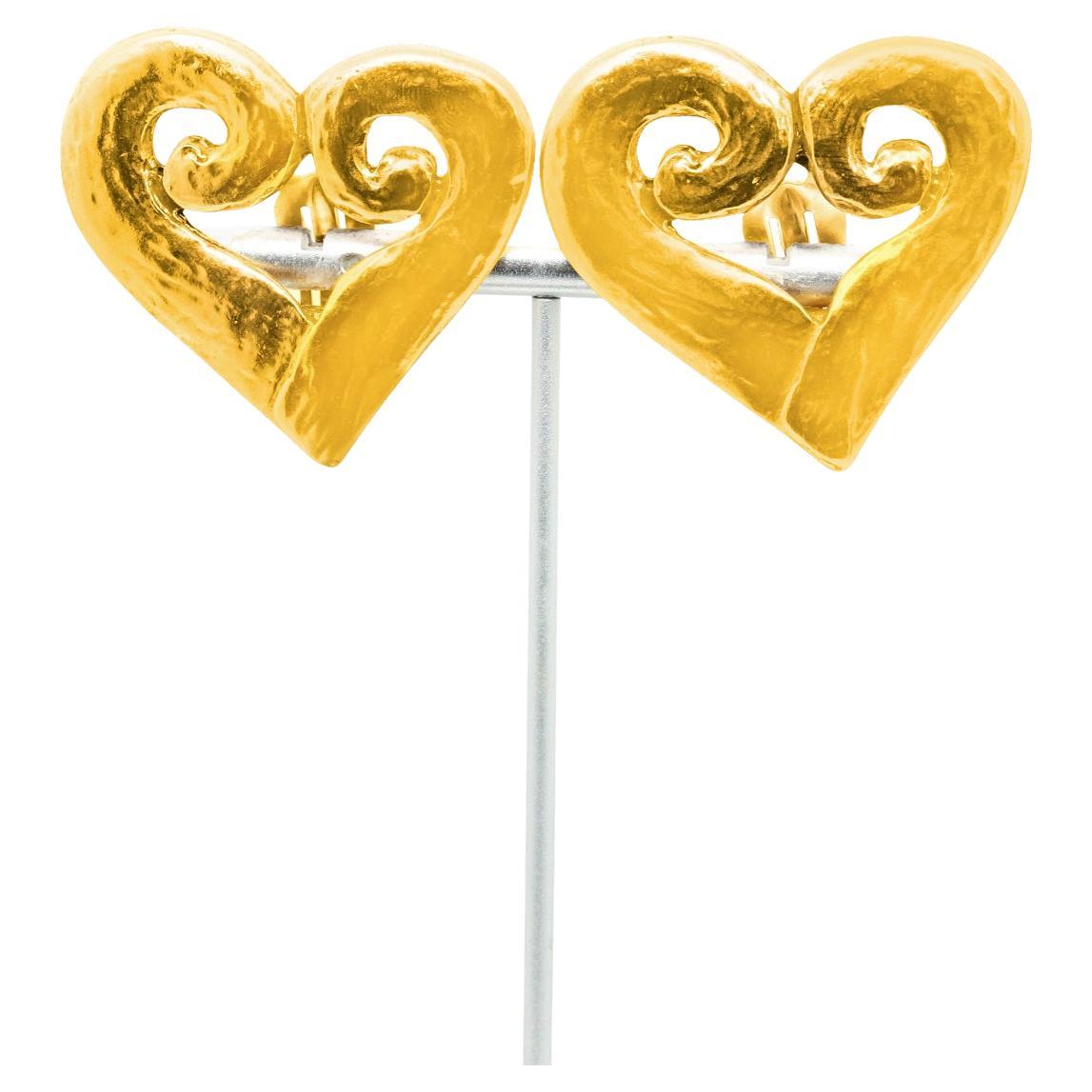 Vintage Yves Saint Laurent YSL Gold Open Heart Earrings. Clip On.  People always know this is YSL. These are very classic earrings that exude chic. 

If you remind me I will send velcro dots so these earrings will comfortably stay on for hours and
